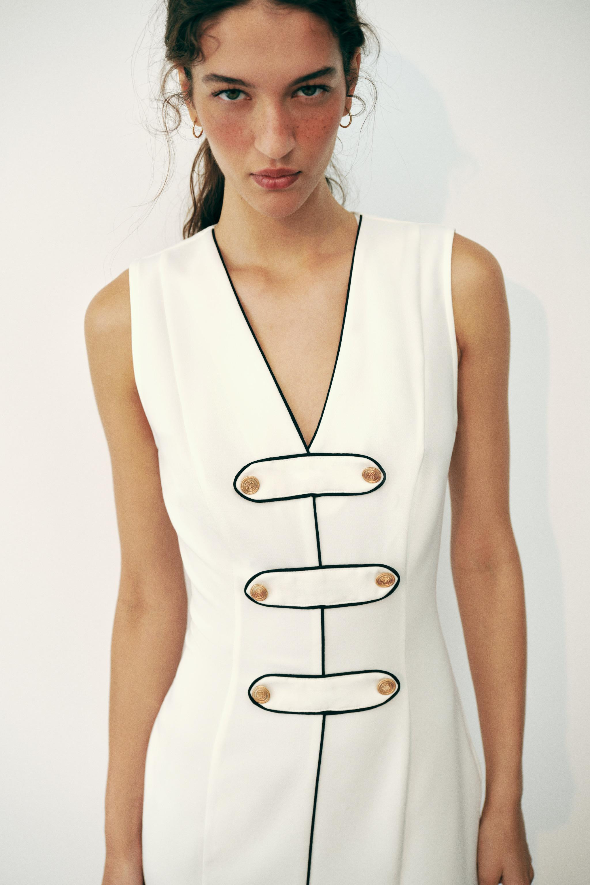 V-neck sleeveless dress. Faux front button detail and contrasting trim. Front slit at hem. Side h... | Zara US