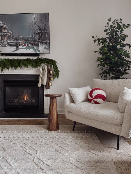 Holiday living room decor. 

Peppermint throw pillow, christmas throw pillow, end table, fireplace decor, Christmas fireplace decor, garland, neutral Christmas decor, neutral Christmas stockings, target style, Kirkland’s, Norfolk pine garland, layered rugs, boucle accent chair, Albany park 

#LTKHoliday #LTKSeasonal #LTKhome