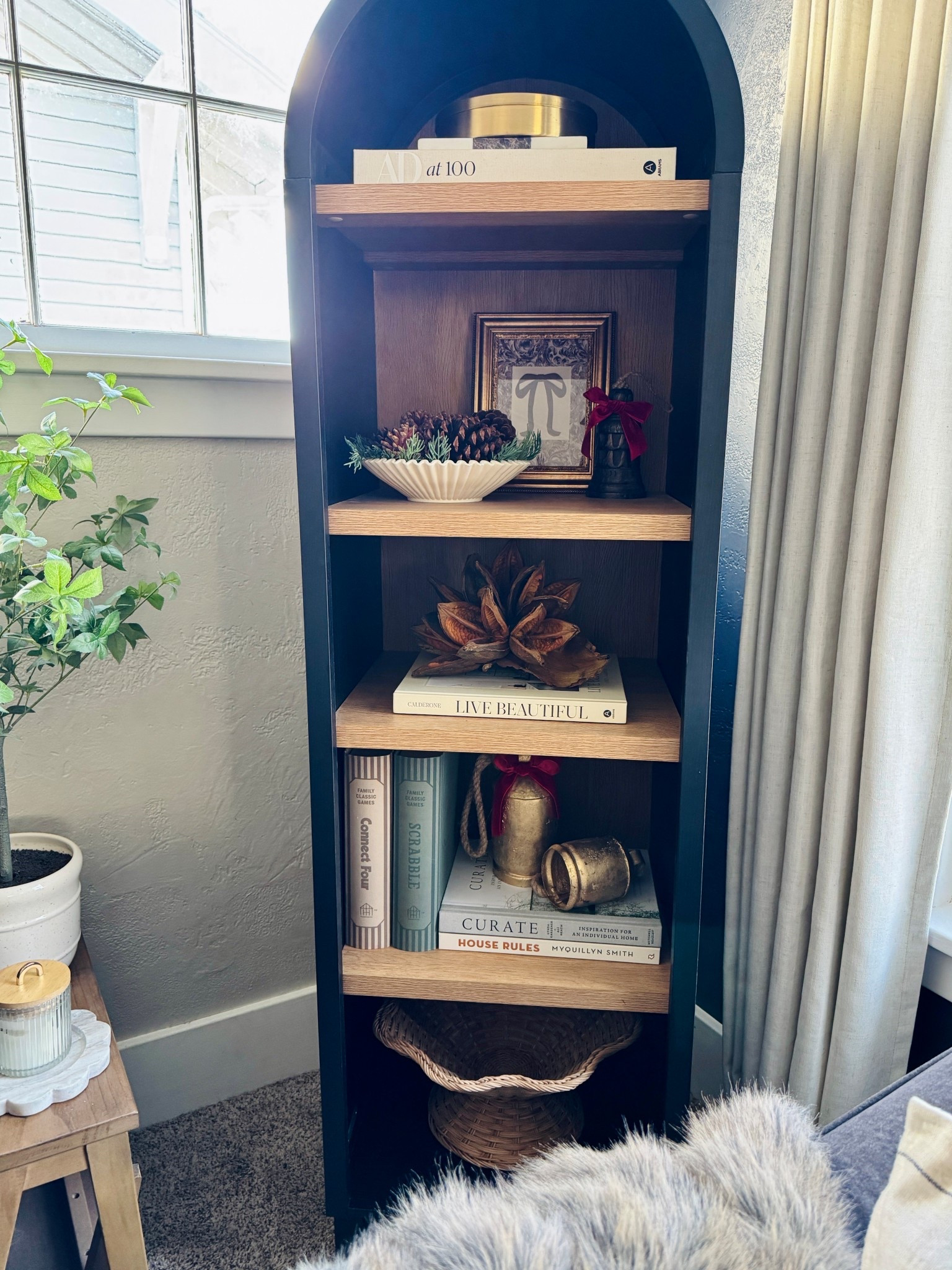 Holiday shelf styling! 

Here’s howI styled my bookcase:
• Added books for height + structure. They go nicely placed on any shelf or table! Have fun and mix items like candles, pictures and/or vases for some added height!
•Grouped items in odd numbers for balance (pick a few statement pieces to incorporate into your groupings)
• Mixed materials: Brass + natural textures to warm it up
• Added some festive touches (pinecones, bells, ribbon)

#shelfstyling #holidaydecor 

#LTKSeasonal #LTKHome #LTKHoliday