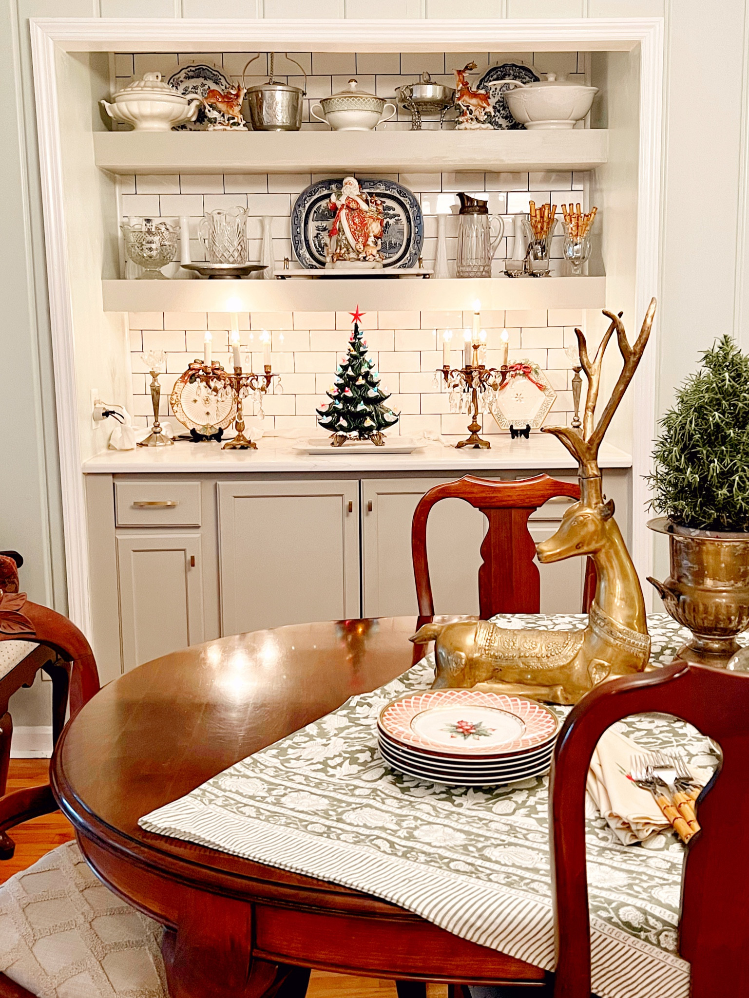 The dining room is ready for a festive fiesta! I just got my Grannie Ella’s table set up in my home, and it reminds me of all the fond memories around it growing up. The ceramic tree was Mama’s last Christmas gift to me, and all the Fitz & Floyd items were given to me through the years by my parents. The red plates are the Fitz & Floyd Winter Holiday pattern. Each year for my birthday and Christmas starting when I was 15, I got a place setting of it. I’m so glad Mama had the forethought to do that. It’s beautiful and exactly what I would have picked out on my own! 

#christmasdecor #christmasinthediningroom #holidayentertaining #hospitality #holidayprep #fitzandfloyd #vintagefitzandfloyd #fitzandfloydchristmas #builtins #shelfie #diningroom #grandmillennial #livingwithantiques #collectedhome #thecollectedlook #homeinspo #decorcrushing #vintagehomedecor #vintagehomecrush #howivintage #freshtraditional  #itsacolorfullifetour #grandmillennialchristmas

#LTKSeasonal #LTKHoliday