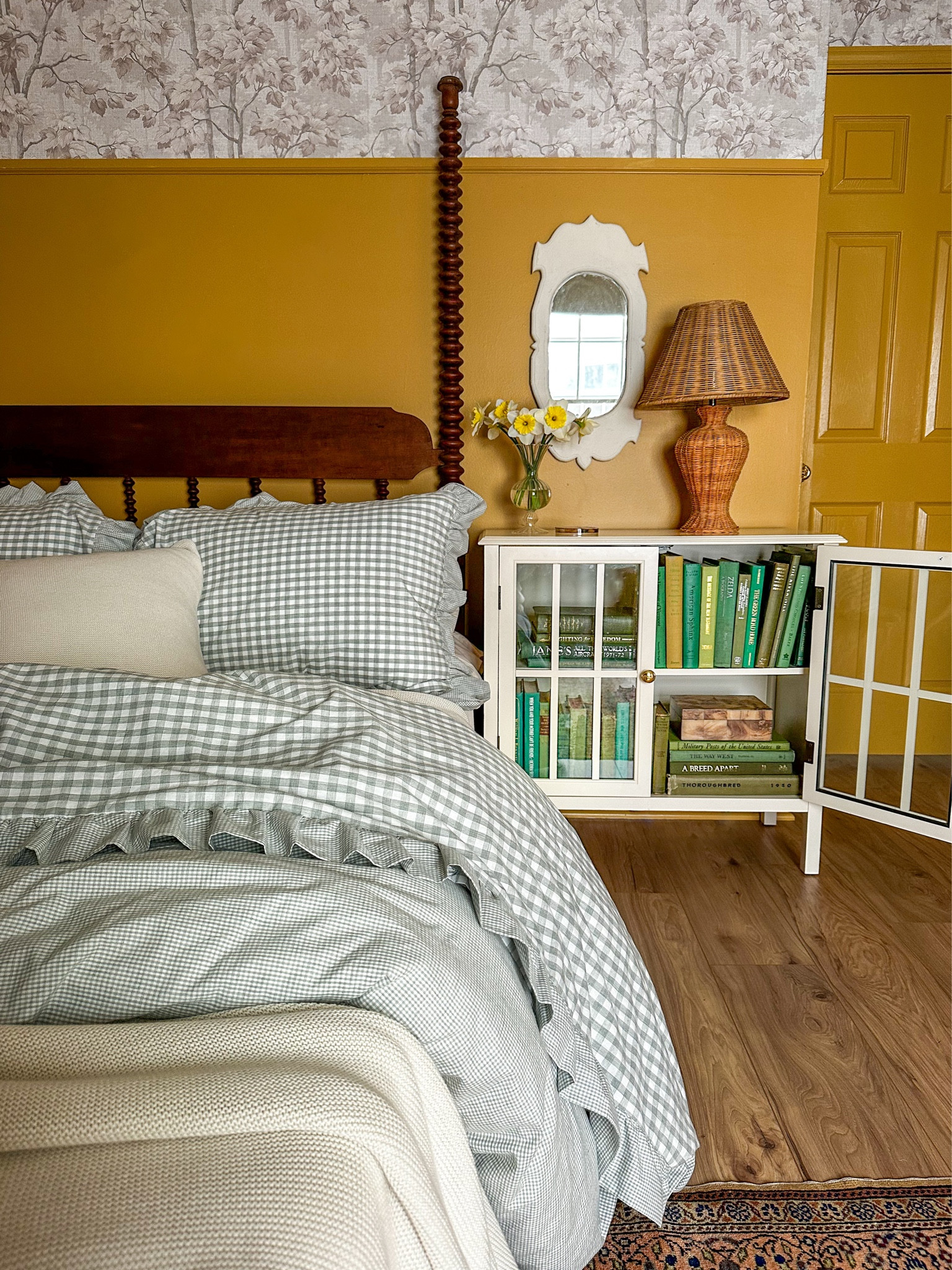 Ruffled gingham bedding - green and gold guest room - wicker lamp, antique books, spindle bed

#LTKhome #LTKSpringSale #LTKsalealert