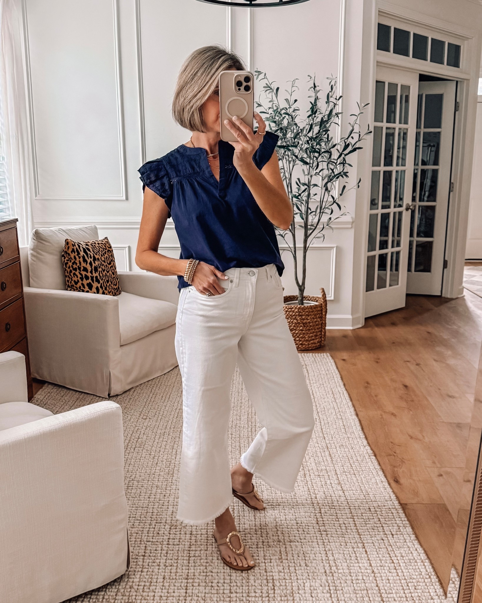 Love the feminine details on this top - little ruffle sleeve and eyelet details. Wearing a size small. The cutest raw hem on these wide leg cropped white jeans. Wearing 27 could have sized up to 28 

#LTKSpringSale #LTKOver40 #LTKootd