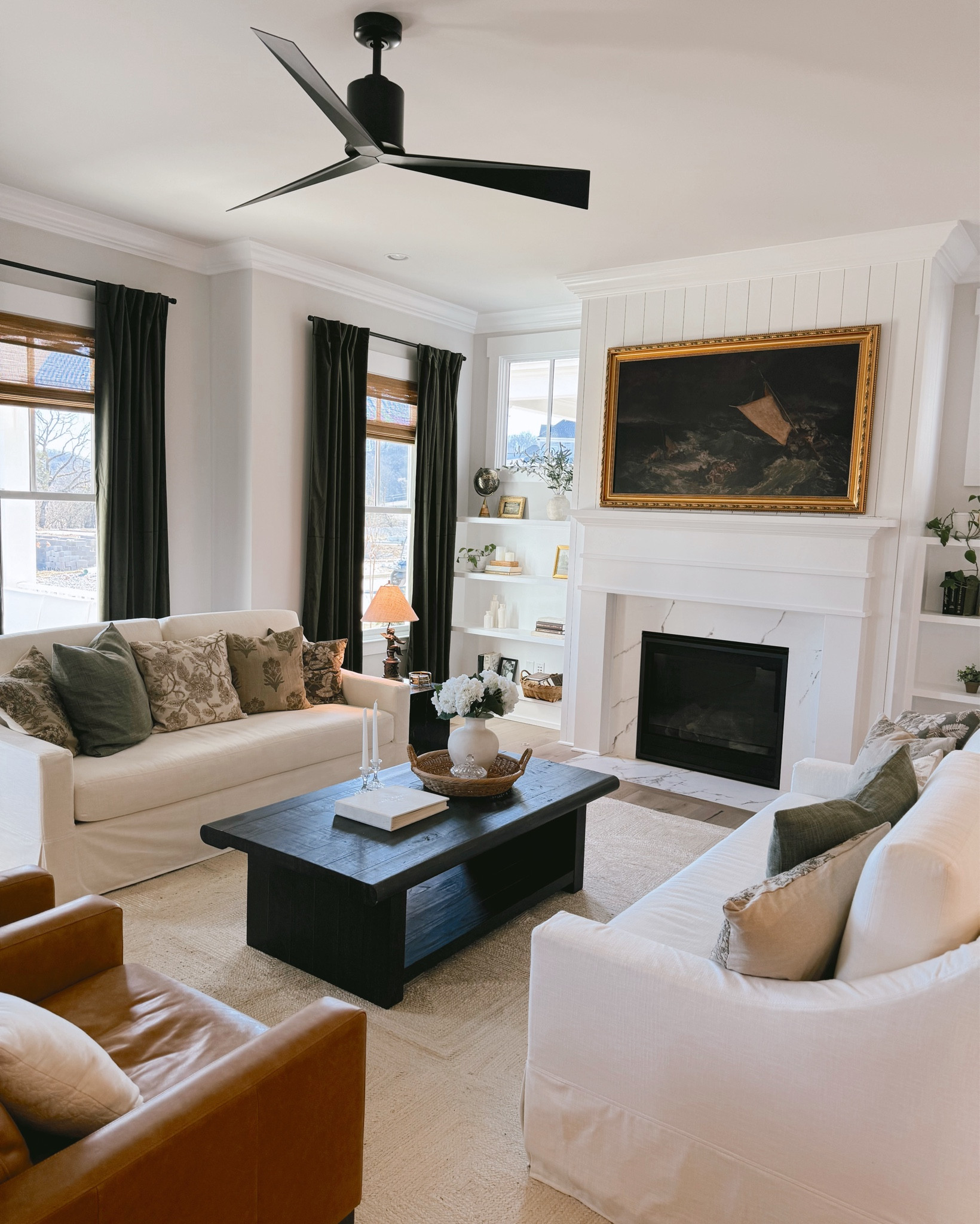 Transitional living room | modern traditional home decor, Samsung frame TV, green velvet drapes, Roman shades, black coffee table, cream linen blend York couch, Italian leather arm chair, bookshelf decor, home decor.

#LTKHome #LTKStyleTip