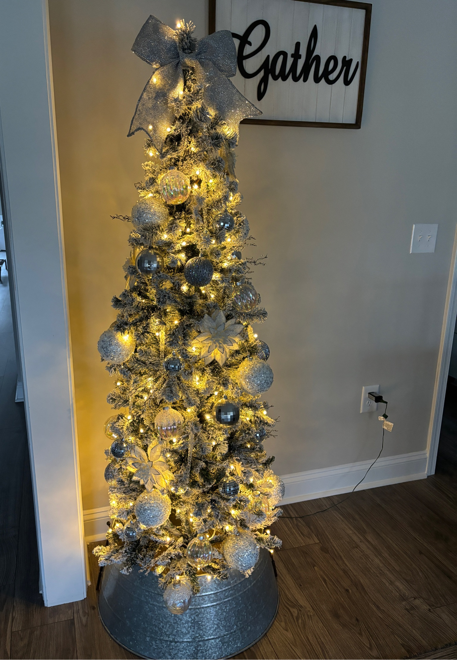 Flocked pencil tree with silver disco ball ornaments and flowers. 

Christmas tree, flocked tree, slim Christmas tree, tree collar, Christmas tree ornaments, silver bow, prelit Christmas tree

#LTKSeasonal #LTKHoliday #LTKHome