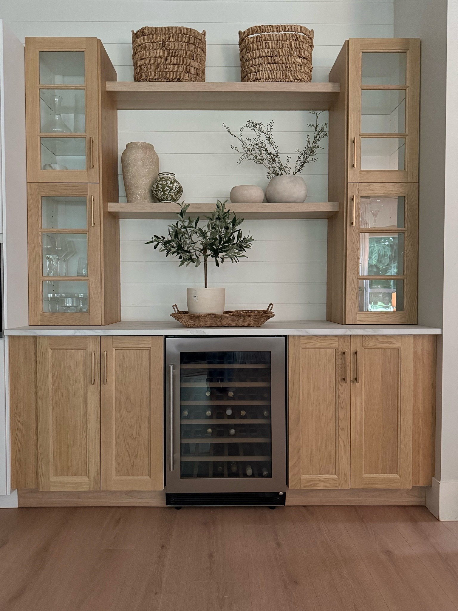 Budget friendly and (sort of) custom built in bar/cabinet. We designed this ourselves at Ikea. They are solid wood door fronts in white oak.