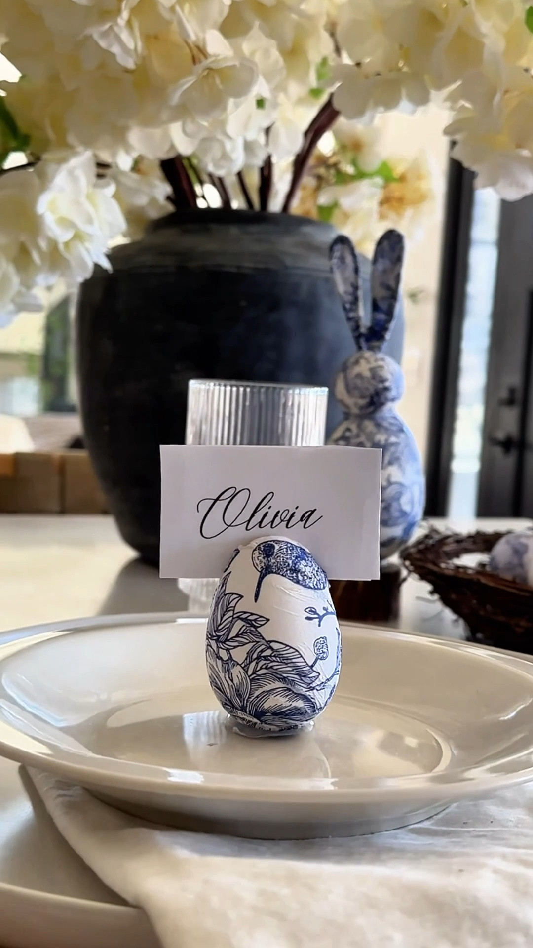 💙 Linking everything I used to make this table setting! To make the egg place card holders:

1. Mod Podge an egg
2. Cut a slit in the top
3. Swirl hot glue on the bottom and set on wax paper to dry. 

Paper napkins , cloth napkins , home decor , table setting , tablescape , Easter table setting , woven chargers , fluted glasses , cherry blossoms , gray vase

#LTKParties #LTKSeasonal #LTKWatchNow