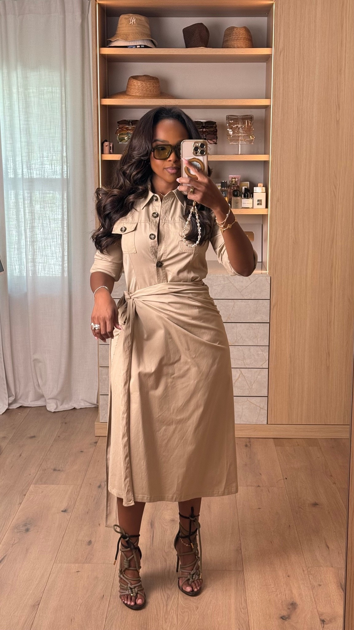 Hi Babes! 🤎✨

I am such a sucker for a good shirt dress, and this one is SO chic.

It has that effortless tailored look while still being incredibly comfortable. The wrap detail cinches your waist beautifully, and paired with these lace-up heels, it instantly looks elevated. This is one of those timeless pieces you'll wear for years.

Fit Details:
• Neutral wrap shirt dress
• Waist-defining tie detail
• Lace-up heels
• Gold jewelry
• Oversized sunnies

Where to wear:
• Office days
• Client lunches
• Brunch with the girls
• Date night
• Vacation dinners
• Baby showers or bridal events

Everything is linked below!

xx, Kira | IG: KirasFashionFinds

Measurements: 5'3" | Wearing Size XS
