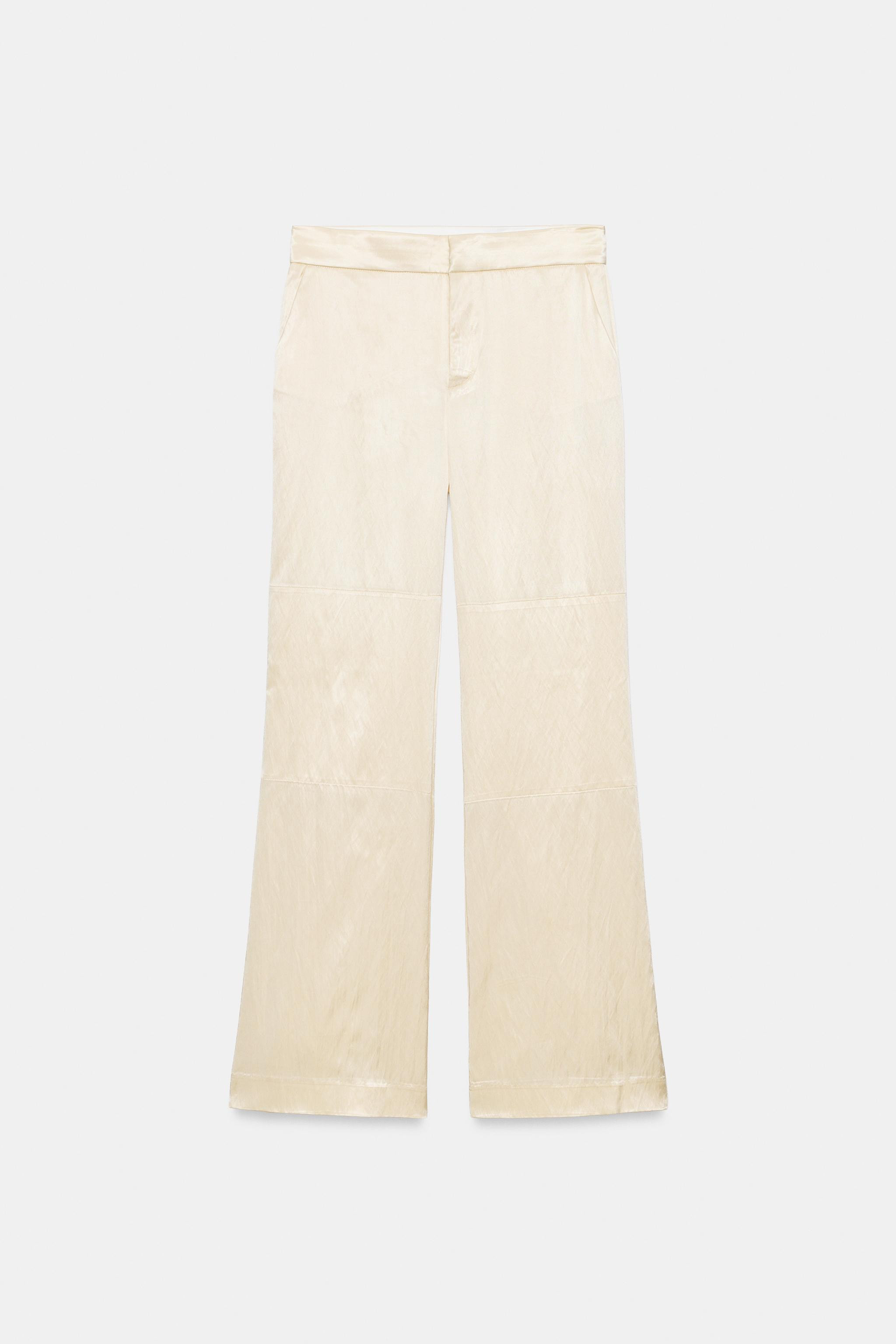 Mid-waist trousers made from satin fabric. Featuring side pockets, overlay fabric detail at the k... | Zara NL