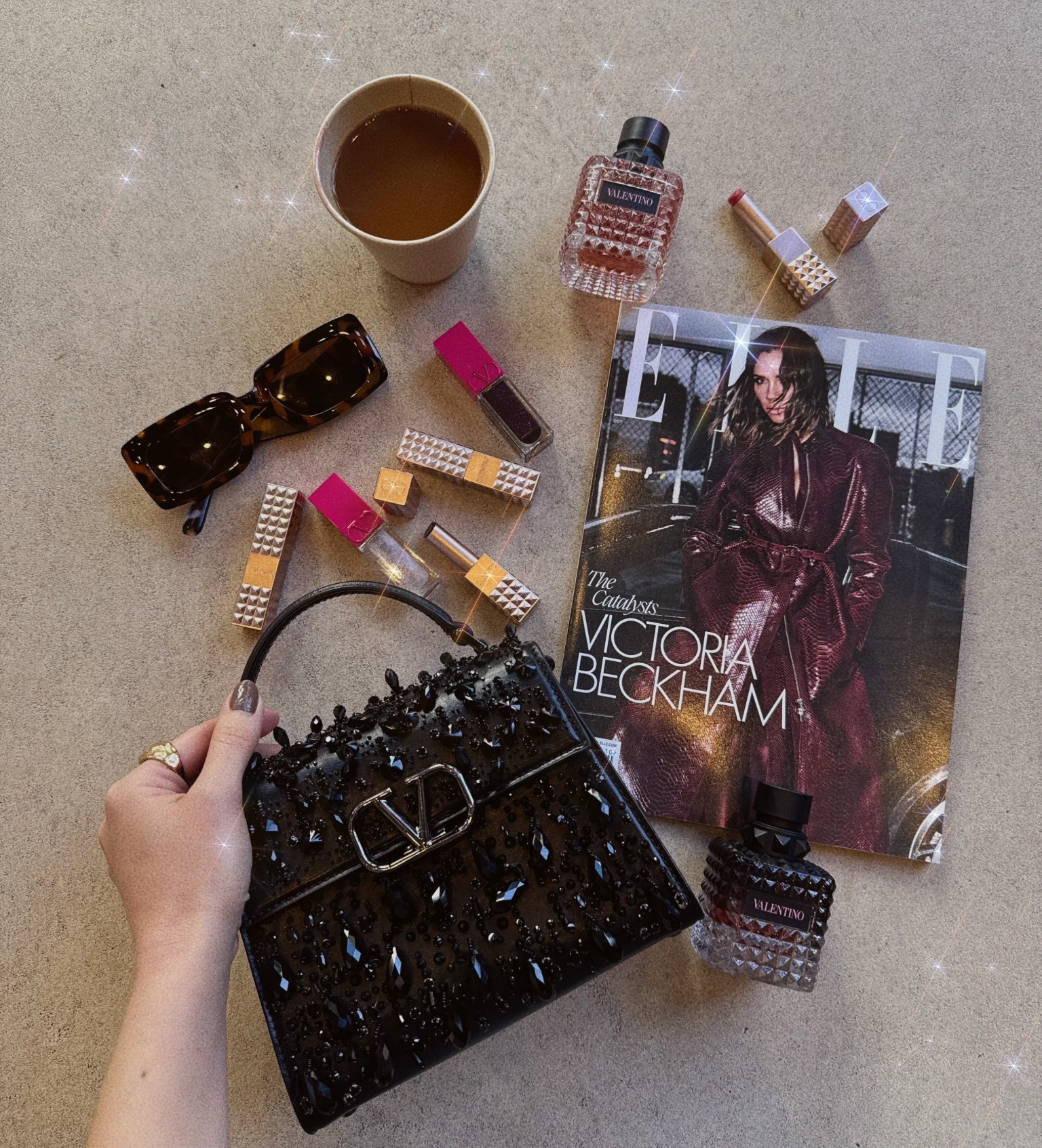 Here's a look inside my bag today: the Valentino Beauty Edition!

I always carry a magazine or a book with me. This week, I've been reading ELLE UK and other European editions of my favorite fashion magazines—it’s a little reminder of where my heart is! 😊 My essentials include a chic statement bag, a delightful coffee or matcha, and my favorite perfume and lip products. 

I have been absolutely obsessed with the Valentino Beauty puffer glosses since last spring; they're wonderfully non-sticky! 🙌🏼 I also love the Valentino Beauty Spike disco balms. They're super lightweight, glossy, and pigmented, feeling like a perfect combination of lipstick and gloss—so there's no need to finish with an additional sheen.

For late fall and winter, I can't get enough of BORN IN ROMA EAU DE PARFUM. Layering DONNA (the perfect reddish-pink) with DONNA Intense has become a delightful routine! ✨ #whatsinmybag #ValentinoBeauty #borninroma #spikevalentinodiscobalm 

#LTKHoliday #LTKGiftGuide #LTKBeauty