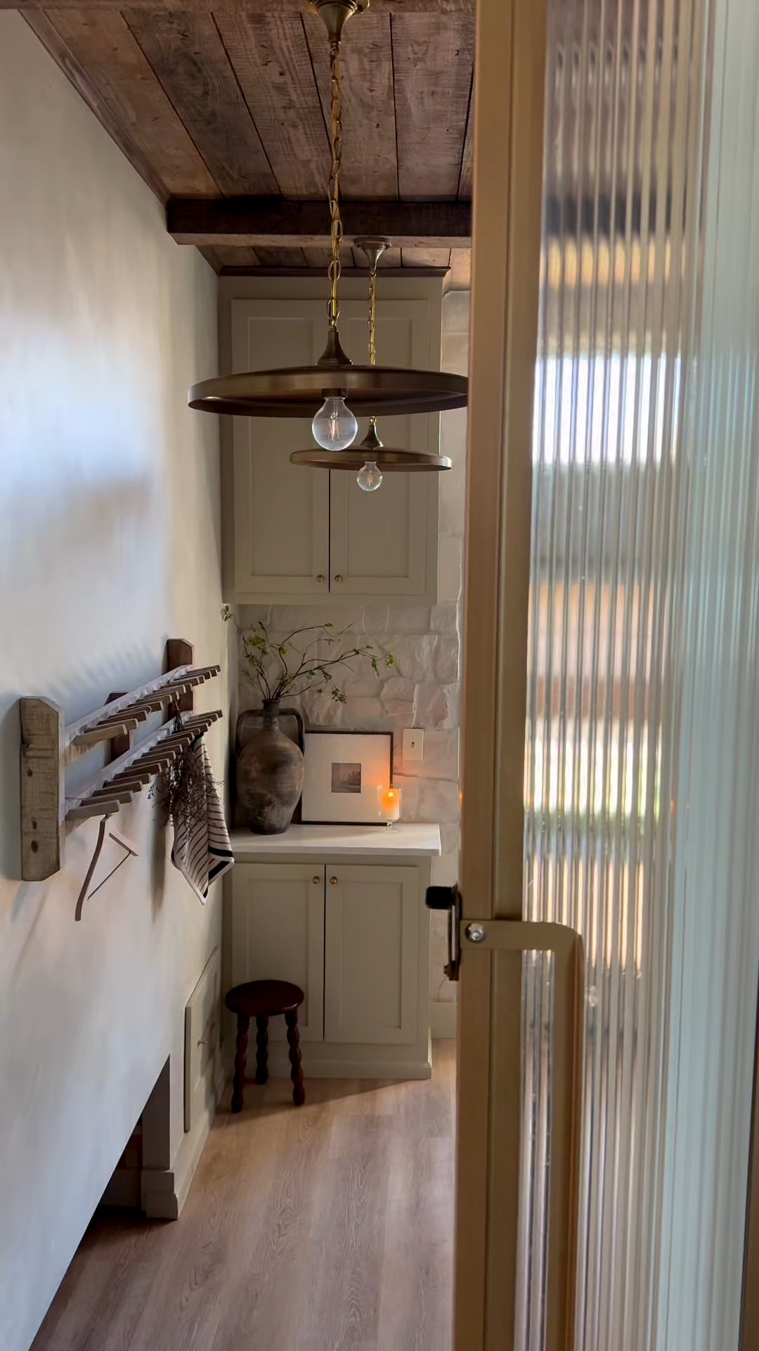 My laundry room. I added some spring florals from Amazon that are super affordable. The tulips come in 3 bundles. I am a real plant snob and these are GOOD for being faux. They even have a realistic feel. I used all 3 bundles in my vase because it’s very large! Yall always ask about my wooden rack as well. Such a unique piece and it is linked as well! My door is from rustica hardware. Sienna sliding door with fluted glass in modern gold. Cabinet color is Sherwin Williams Naturel. Flooring is also linked. This is only the flooring in my laundry room. I’m not certain on brand or color of the flooring throughout the rest of my home  

#LTKSeasonal #LTKHome