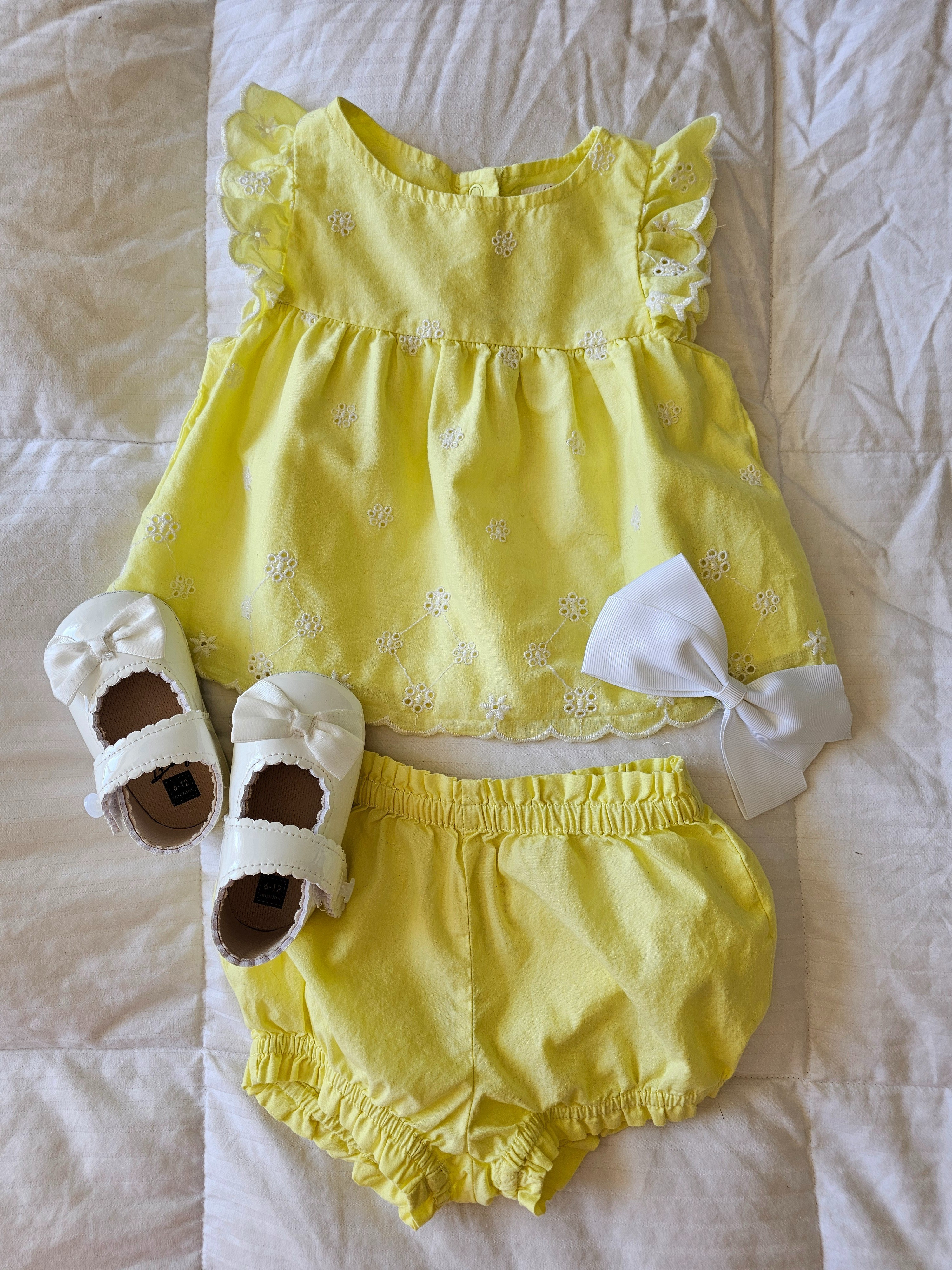 Yellow eyelet spring summer set top and bloomer outfit, white clip bow, white patent satin bow Mary Jane strap on velcro shoes

#LTKgrwm #LTKootd #LTKBaby
