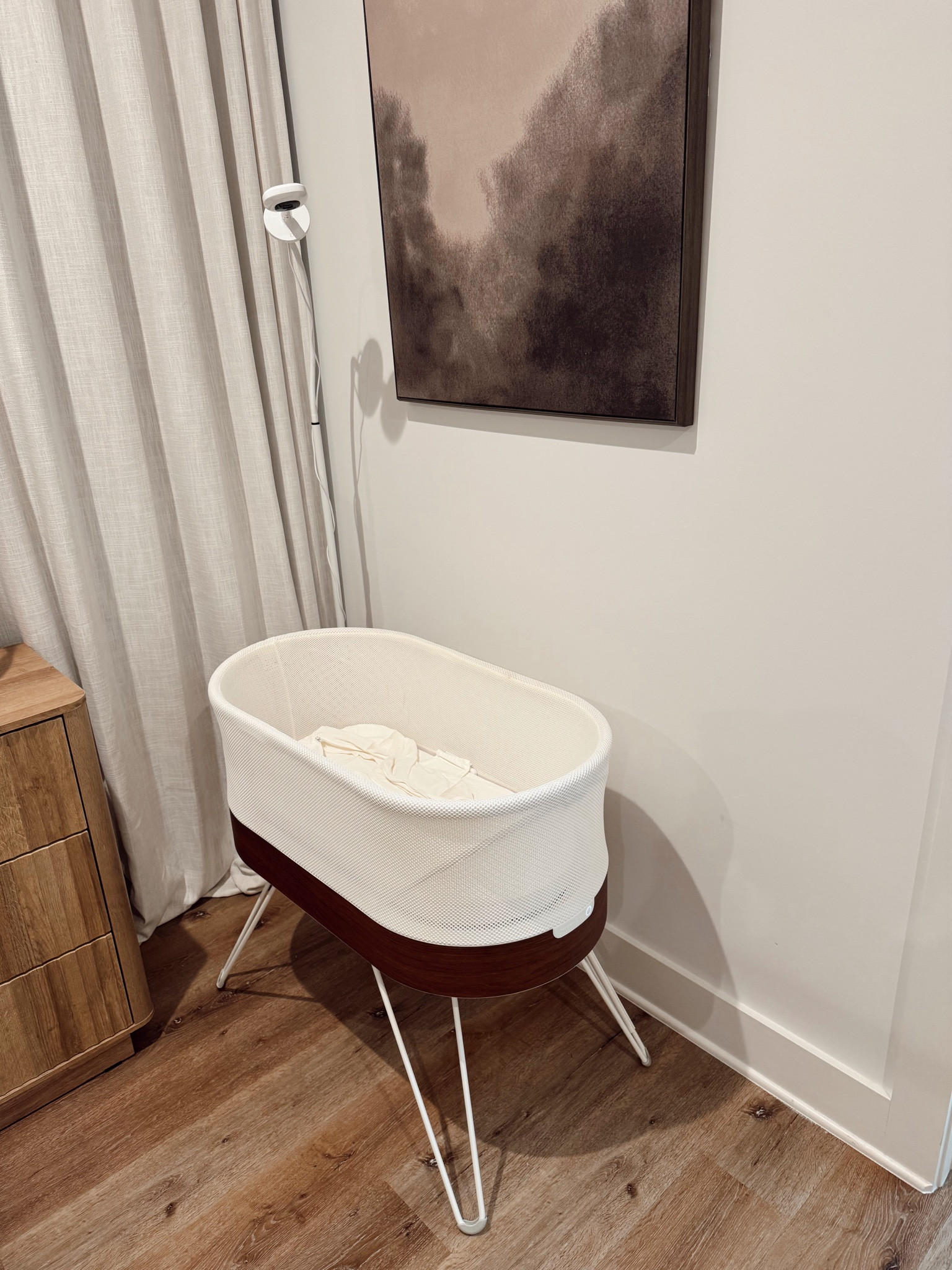 Baby in our room set up with the SNOO and monitor beside our bed! 