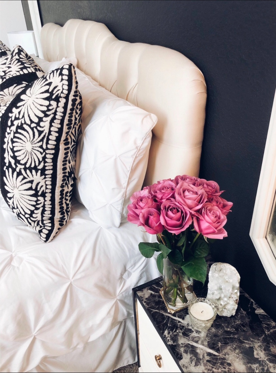 Black and white bedroom styling idea with pleated bedding, a tufted headboard, Peruvian design pillows, black marble nightstand, crystals, and pretty pink roses. 

Bedding, master bedroom, guestroom, blanket, duvet, elegant modern glam, home decor, flowers, florals 

#LTKHome #LTKFindsUnder50 #LTKSpringSale