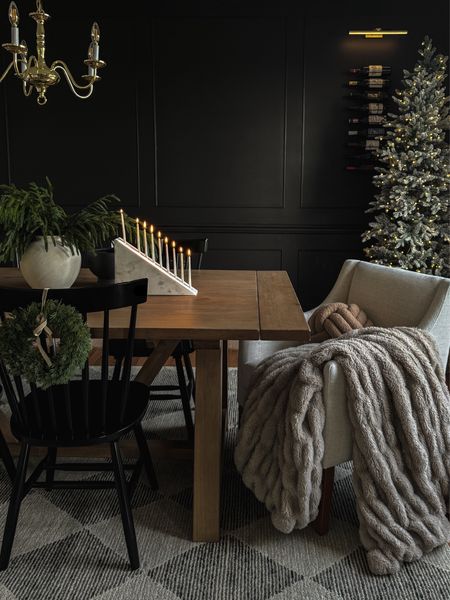Table: Leona Farmhouse Extension Table in Graywash

Accent wall: Black Magic by Sherwin Williams 

Modern menorah, moody dining room, black accent wall, Christmas dining room, mini wreath, marble menorah, throw blanket, dining room accent chair, crate & barrel, Norfolk pine stems, dining table, black dining chairs

#LTKHoliday 

#LTKSeasonal #LTKhome