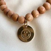 smiley face stamped bracelet | delicate rosewood | Reef rain aria