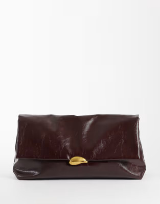 ASOS DESIGN oversized clutch in burgundy with hardware detail | ASOS (Global)
