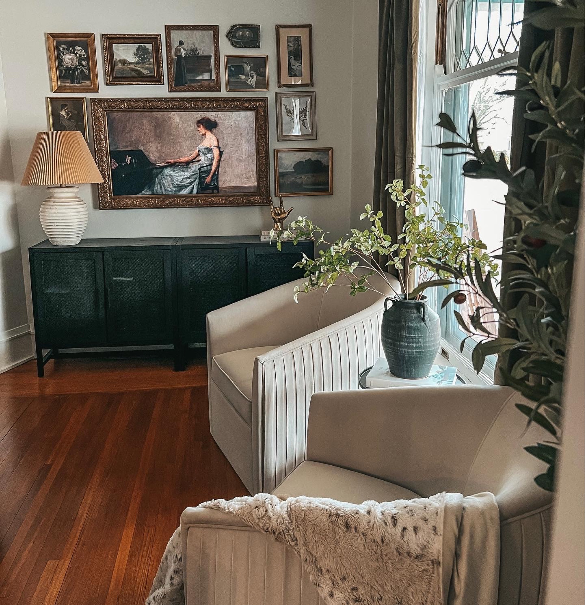Shop this space. Gallery wall. Framed television, Vintage prints, frames, Target cabinets, decorative brass hand, accent chairs and home decor. 
Kathykuohome

#LTKFind #LTKhome #LTKstyletip