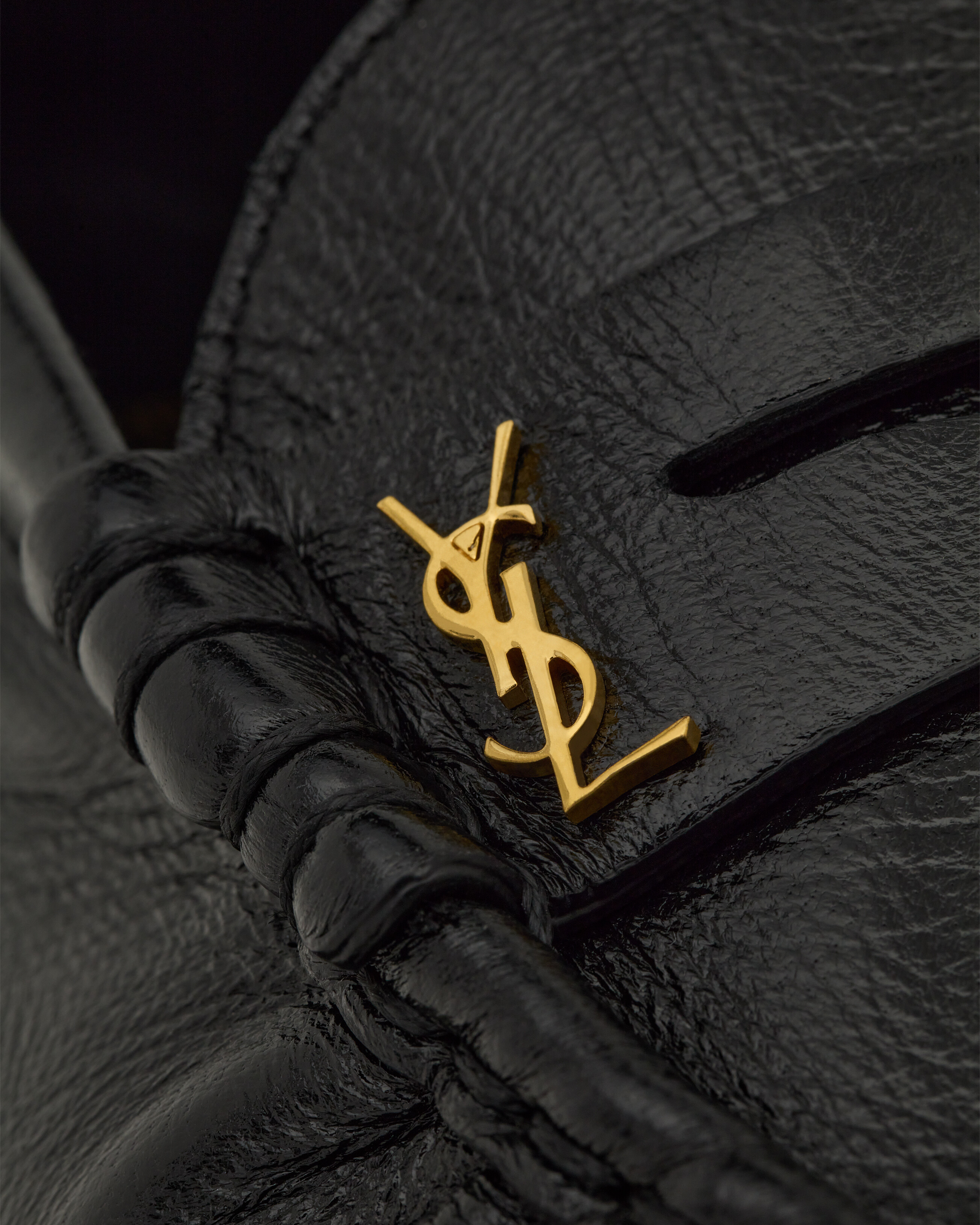 supple penny loafers decorated with the CASSANDRE, featuring a hand-stitched moc toe. | Saint Laurent Inc. (Global)