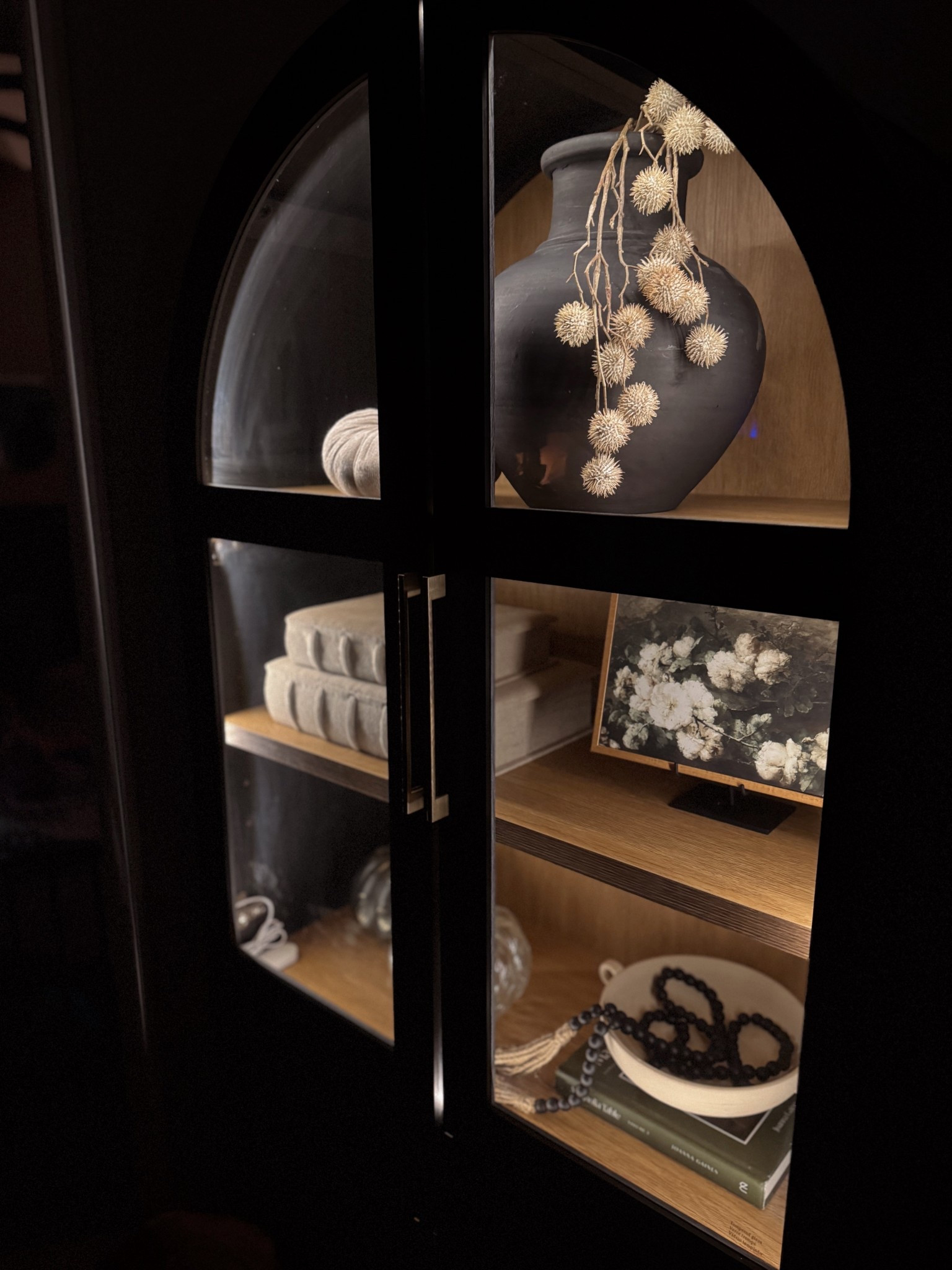 This arched cabinet feels so much more elevated with a soft LED glow ✨ The lighting highlights the decor and adds the perfect cozy touch to the space.

#ltkhome #cabinetstyling #archcabinet #neutraldecor #cozyhome #homestyling
