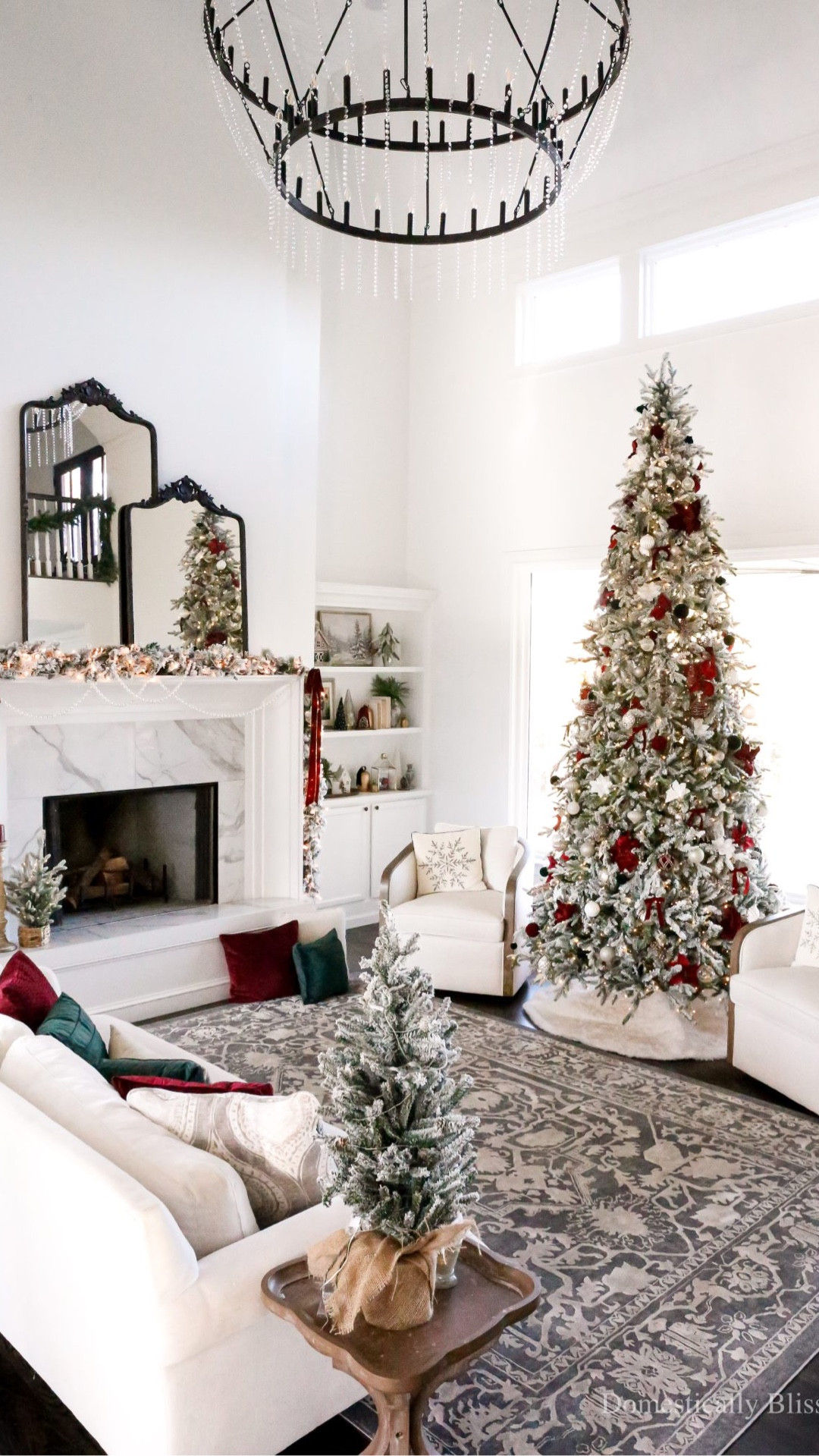 Cozy traditional Christmas Living Room Decor with a 12-foot flocked Christmas tree, flocked garland, and flocked wreaths, with deep red and forest green accents.

See details:
https://domesticallyblissful.com/christmas-living-room-decor-2025/

🔗 Join our newsletter: https://domesticallyblissful.com/newsletter/ 

#LTKHome #LTKSeasonal #LTKHoliday