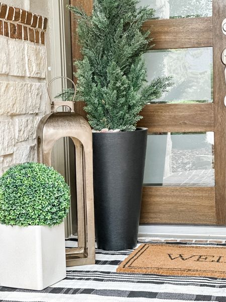 A close up of my porch with my recent purchases from Target and Walmart. Love the faux topiary and heavy duty lantern!! Perfect for a pitch look or backyard decor

#LTKSeasonal #LTKhome #LTKstyletip