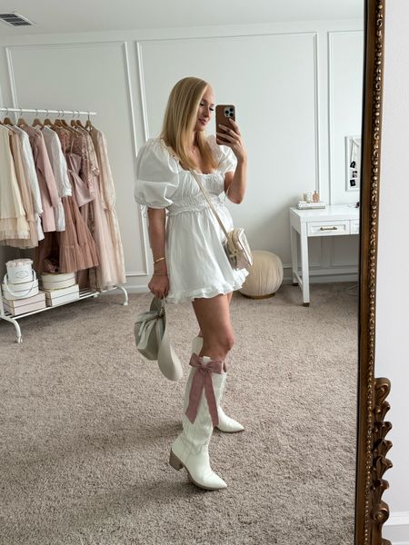 My outfit for the Kenny Chesney concert tonight! Rewearing this little white dress (size medium) with my white cowgirl boots and my kemo sabe hat. I added a cute pink bows to my boots. 

Country concert outfit // white cowboy boots // western boots 

#LTKSeasonal #LTKFestival
