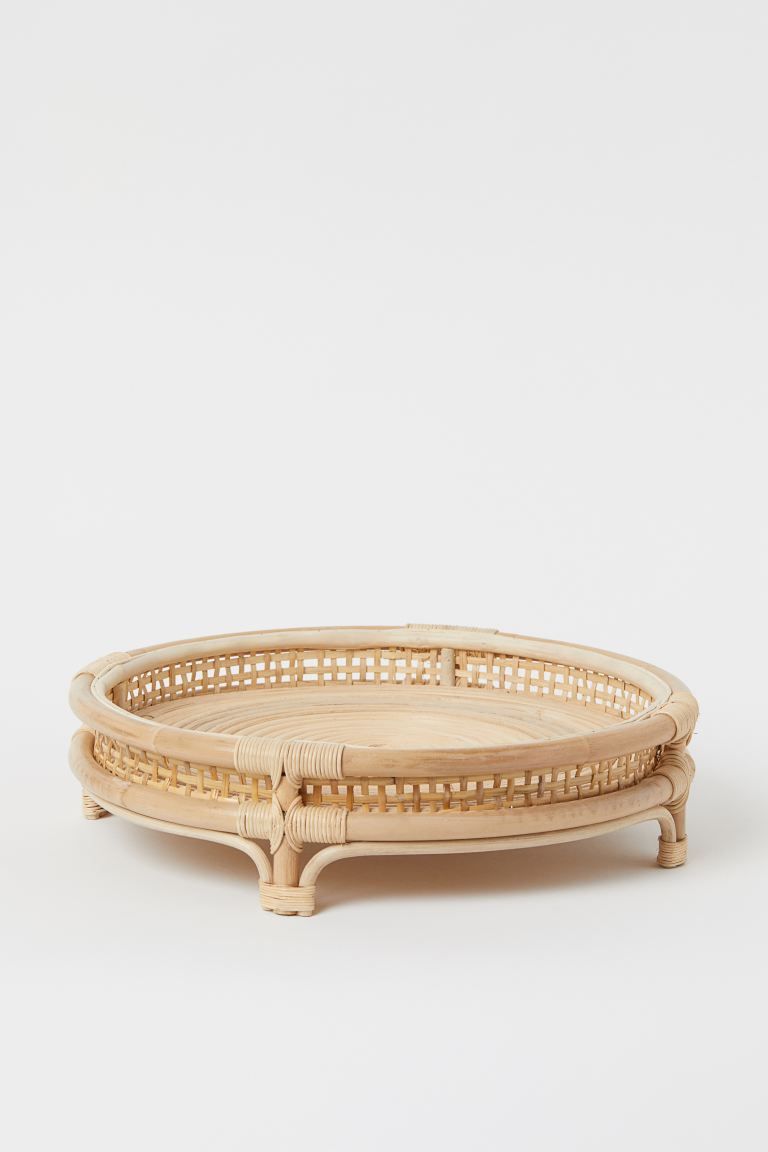 Round tray in rattan with braided sides and a fixed frame on legs. Diameter approx. 13 3/4 in. He... | H&M (US + CA)