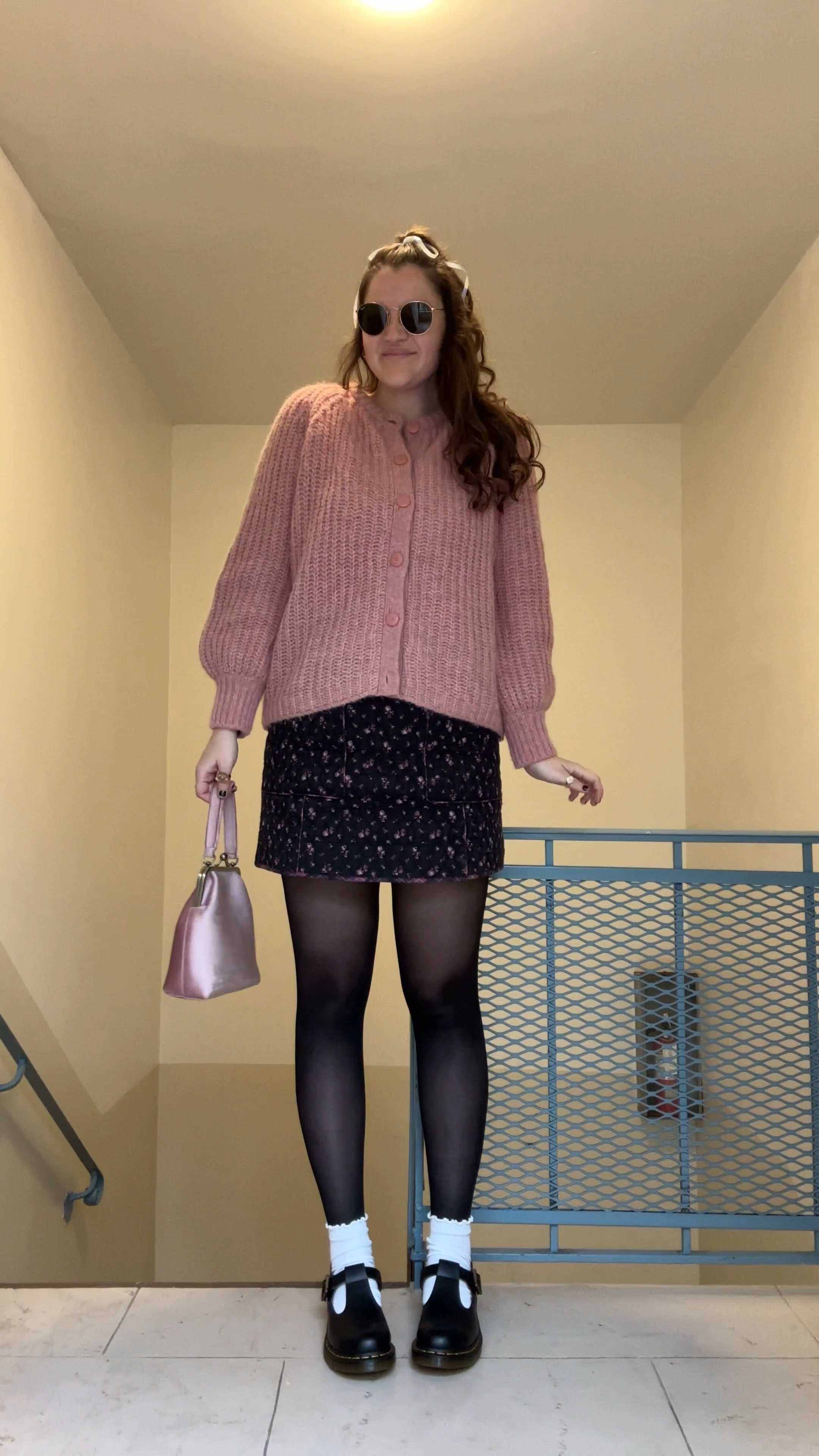 sezane EMILE CARDIGAN Mottled Pink, pastel, fall / winter, Alpaca and wool cardigan with long sleeves, Slightly oversized volume, sezane BETSY mini SKIRT Maxi Floral Patchwork, Quilted and printed short skirt, black and pink, Dr. Martens POLLEY SMOOTH LEATHER MARY JANES, black casual shoes, fall / winter, comfy shoes, amazon Cute Ruffle Ankle Socks for Women - Soft Cotton Knit Lettuce Low Cut Frilly Crew Socks, white socks, thin white satin ribbon from amazon for hair bow, rayban round sunglasses, gold jewelry from Amazon (hoop earrings, rings), colorful clothing, black tights, pink top handle bag / purse

#LTKfindsunder50 #LTKstyletip #LTKfindsunder100