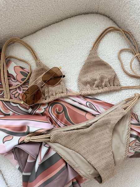 Devin Windsor Styling 🐚 | Carley Bottom - cheeky bottom w/ braided detail | Clio Top - triangle w/ adjustable double braided back straps | 🤎 Lagos Sunglasses in *brown* | Sarong - wrap w/ side tie + one size fits all. Are you a neutral or bright colored swim girl? Drop it in the comments! 🌊 #Swim #SwimStyle #SandyTones #Vacation #ResortWear #SweetSummertime 

-xx Rachael 

#LTKswim #LTKstyletip #LTKtravel