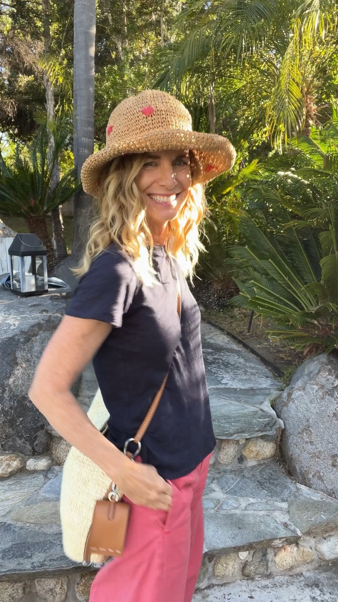 Cute Spring Summer outfit! The cutest raffia hat with red hearts. A raffia and leather purse that adjusts from a double strap to a long crossbody bag. Washed red barrel pants and navy t-shirt. 

I’m 5’4” wearing xs and pants 25#LTKover40

#LTKSeasonal #LTKVideo