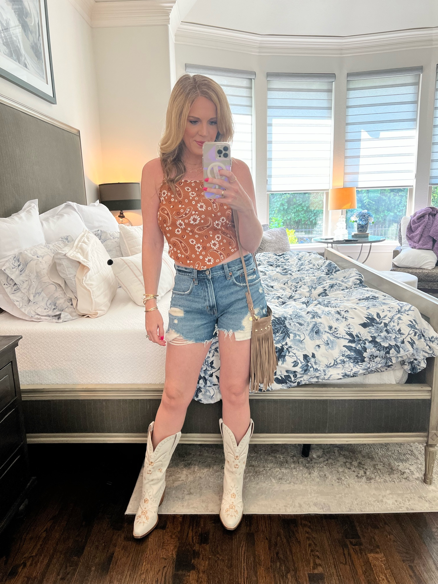 Country concert look 
Western style 
Western look 
Bandana top 
Cut off denim shorts 
Distressed denim shorts 
A&F denim shorts 
Abercrombie shorts
Cowboy boots 
White cowboy boots 
Western boots 
Embroiderer leather boots  

#LTKShoeCrush #LTKFindsUnder100 #LTKSeasonal