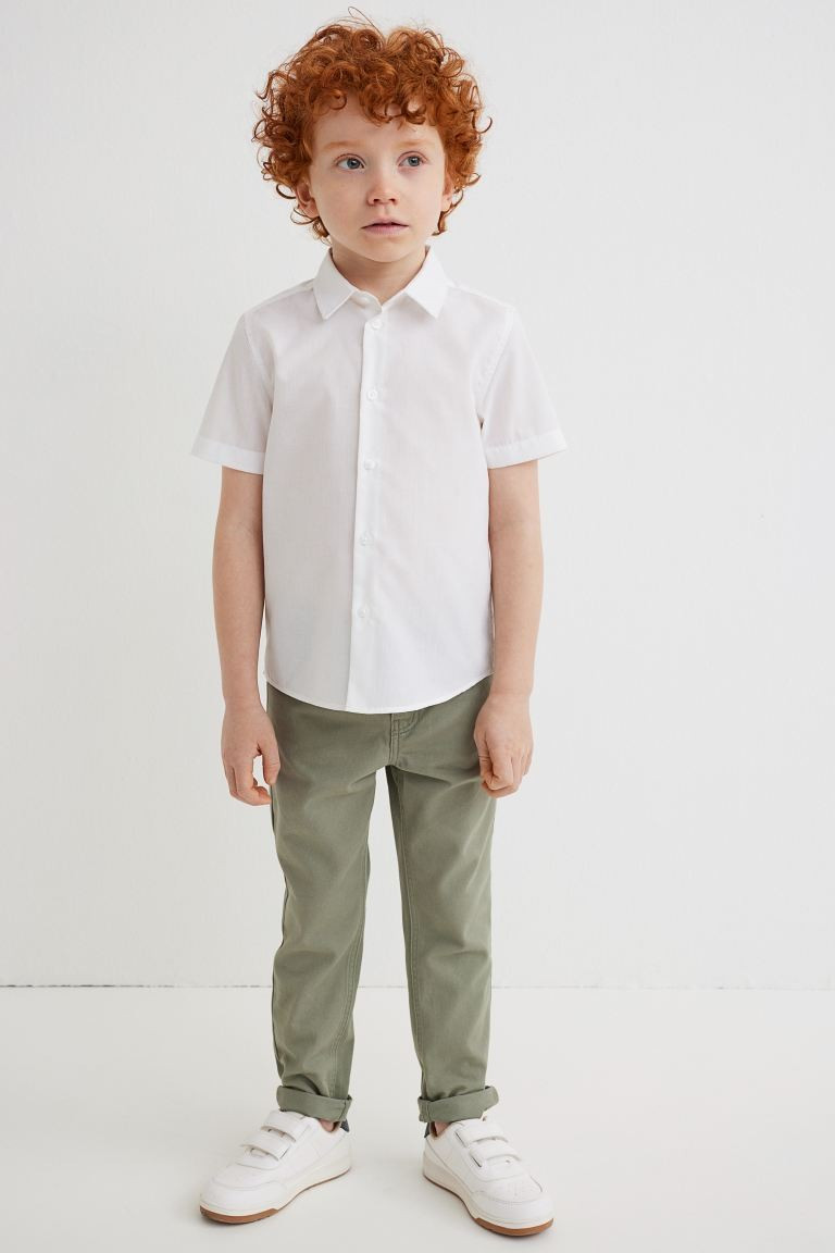 Slim-fit pants in cotton twill. Adjustable, elasticized waistband, zip fly with snap fastener, an... | H&M (US + CA)