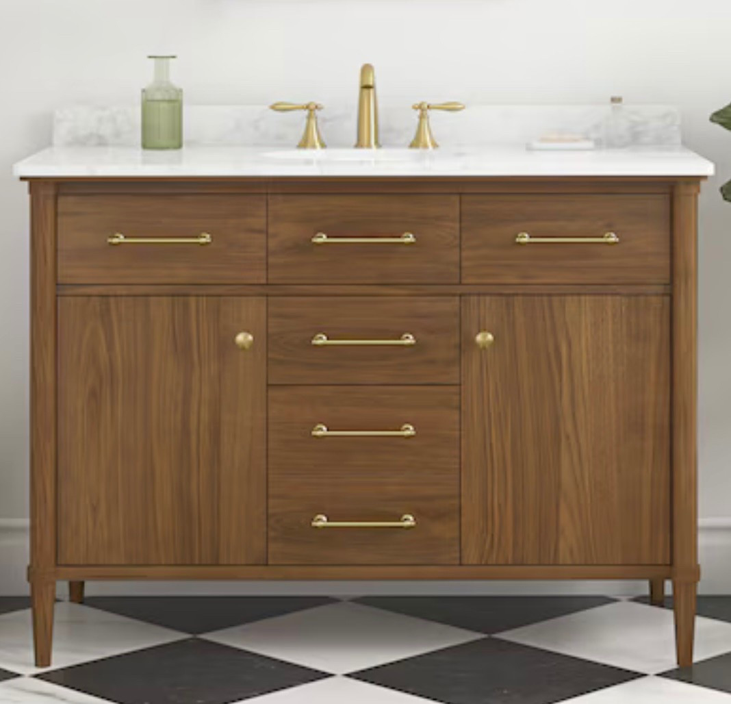 Warm walnut bathroom vanity with brass accents and a beautiful stone top. 

#LTKHome