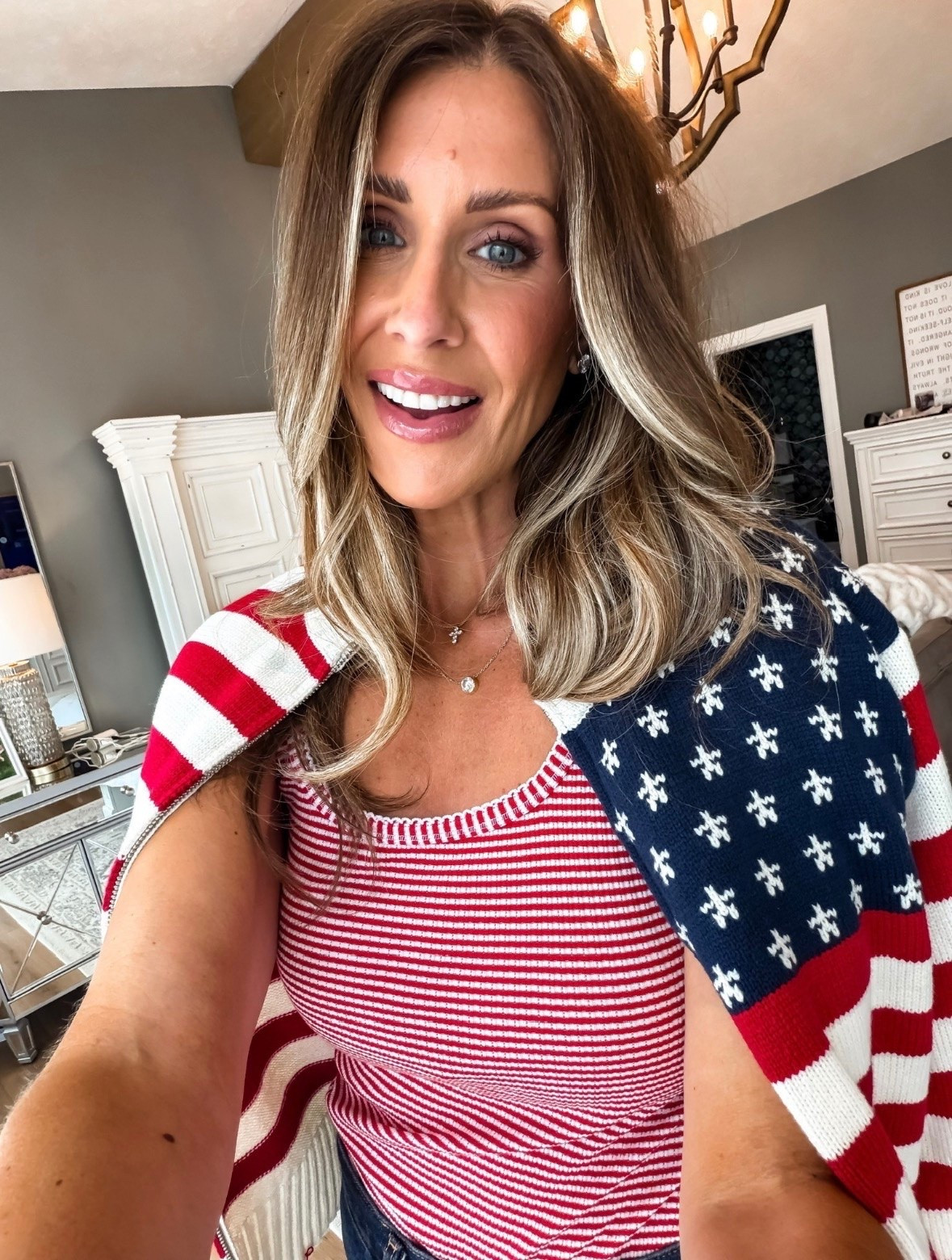 This patriotic knit tank and American flag sweater are such a cute combination for summer holidays. I love how you can wear the sweater over your shoulders for a classic look, then throw it on when the evening cools down.

patriotic outfit, American flag sweater, striped knit tank, Fourth of July outfit, red white and blue style, summer holiday outfit, patriotic fashion, summer layering, classic summer style, holiday weekend outfit, summer knit top, themominstyle

#LTKootd #LTKSeasonal #LTKOver40