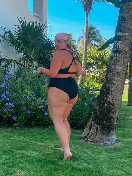 This Amazon Prime plus size swimsuit gets my stamp of approval! There is enough coverage for my chest on the sides, top and bottom (we love a no-spill top!), and decent support for it being non-wired. The thick band is providing some extra support for the bust, which we love to see! The tie around element is attached on each side, so you can tie to the front or back, lower down like I have it here or under bust for some additional “band” like support. The shoulder straps are not adjustable on this swimsuit, but you can adjust how low the swimsuit hits on your back by moving it around. When it comes to the bottom half, feel super held in and supported with my stomach. The booty is a bit cheeky but nothing wild!  Shop the $30 plus size Amazon bikini in sizes XL-4X and 10+ color variations. I am wearing XL.

#LTKfindsunder50 #LTKswim #LTKplussize