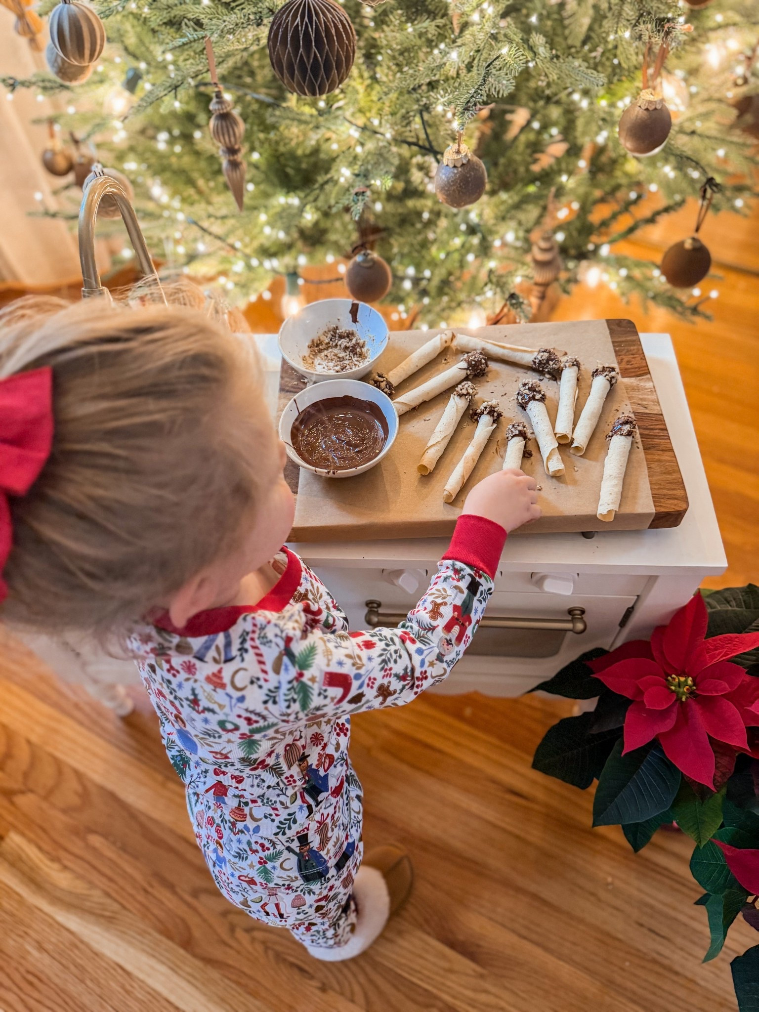 Baking Christmas cookies in her pottery, barn, kids, rifle paper, Co. Nutcracker pajamas with her pottery barn kids penny scalloped play kitchen 

#LTKmomlife #LTKHoliday #LTKKids