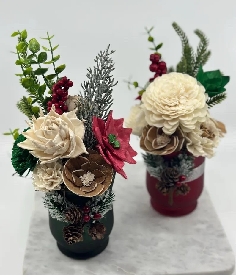 Bring cozy, festive elegance into your space with this handcrafted holiday sola flower arrangement, styled in a charming frosted vase for the perfect winter touch. Featuring natural sola wood flowers, pinecones, berries, frosted greenery, and layered seasonal textures, it’s an eye-catching centerpiece for holiday tables, mantels, or shelves. Available in classic red or green vase options, this long-lasting arrangement makes a thoughtful Christmas gift and a beautiful way to decorate year after year—no wilting required.

#LTKhome #HolidayDecor #ChristmasCenterpiece #SolaFlowers #WinterDecor #HandcraftedDecor #ChristmasHome #FestiveStyle

#LTKHoliday #LTKHome #LTKSeasonal