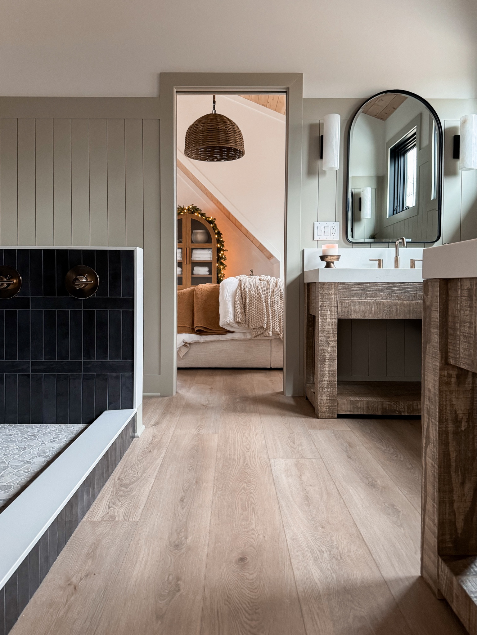 Rustic modern bathroom between two sleeping areas. These wood vanities are the perfect addition to this space. The paneling wall color is SW jogging Path and the floors are from Hewn. They are from the Becki owens collection & the color is weathered. 

#LTKStyleTip #LTKHome