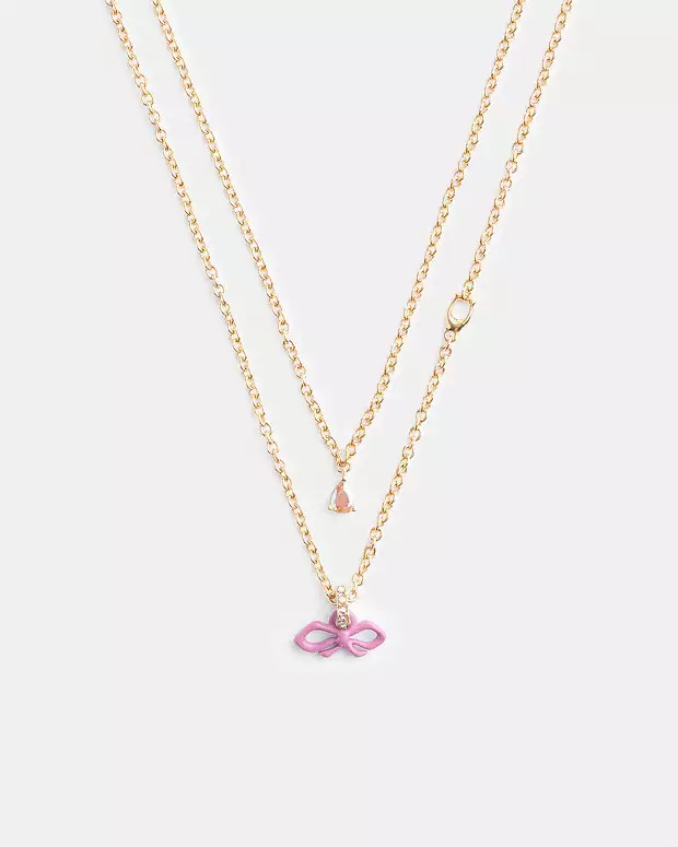 Mini Bow Layered NecklaceRating5.0$59(50% off)Comparable Value$118Color: Gold/Pink | Coach Outlet US