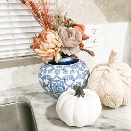 2023 Fall is in the air, and that means it's time to start decorating for the season! This beautiful photo of my kitchen counter shows a simple yet elegant way to add a touch of fall to your home. A blue and white vase is filled with flowers, and it is sitting on a counter next to the sink. The flowers are a variety of soft colors, including peach , beige, and lavender. 

The colors are warm and inviting, and the flowers and pumpkins add a touch of fall without being too overwhelming. The vase is also a great conversation starter, and it would be perfect for a fall gathering.

If you're looking for a way to add a touch of fall to your home, this photo is a great inspiration. With a few simple pieces, you can create a beautiful and inviting space that will welcome the fall season.

**Here are some tips for recreating this look:**

* Use a blue and white vase to create a classic fall look.
* Fill the vase with a variety of flowers in soft autumn colors.
*Add a rope braided pumpkin and a white pumpkin to create a visual triangle. 
* Add a few fall-themed accessories, such as a candle or a throw pillow, to complete the look. .
.
.
.
.
.
.
. .
.
.
.
.
.
.
. .
.
.
.
.
.
.
.
#kitchendecor #kitchendesign #kitcheninspiration #kitchen #kitchenrenovation #kitchenideas #kitchens #kitchendetails #kitchendecoration #dreamkitchen #kitchenware #kitchenorganization #kitchendesignideas #kitchenaccessories #kitchenstyling #kitchentrends #farmhousekitchen #kitchendecorideas #kitchenmakeover #kitchenutensils #kitchentools #kitchenwares #kitchenstorage #kitchendecorations #kitchendecorating #kitchendecoratingideas #kitchendecors #kitchendecorationideas #kitchendecorinspiration #julieannrachelle
#potterybarn #potterybarnkids #potterybarnstyle #potterybarnteen #potterybarnbedding #potterybarninspired #potterybarndecor #potterybarnhome #westelm #crateandbarrel #restorationhardware #ltkhome #julieannrachelle
#falldecor #falldecorating #autumndecor #pumpkindecor #pumpkins #fallhomedecor #halloweendecor #falltablescape #seasonaldecor #autumndecorations #julieannrachelle


#LTKunder100 #LTKhome #LTKSeasonal