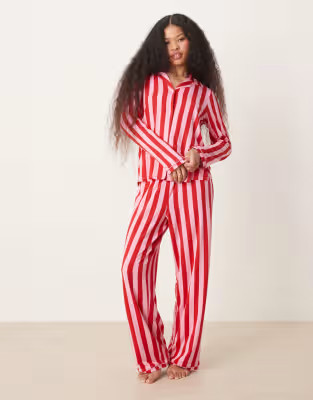 Urban Threads Petite Christmas poly long sleeve revere and trouser pyjama set in pink and red str... | ASOS (Global)