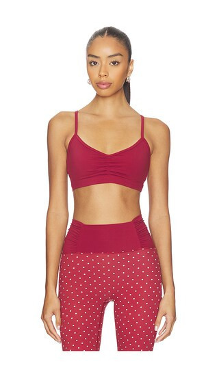 Astoria Adjustable Sports Bra in Wine. - size S | Revolve Clothing (Global)