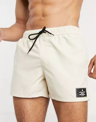 ASOS Unrvlld Spply swim shorts in beige short length | ASOS (Global)