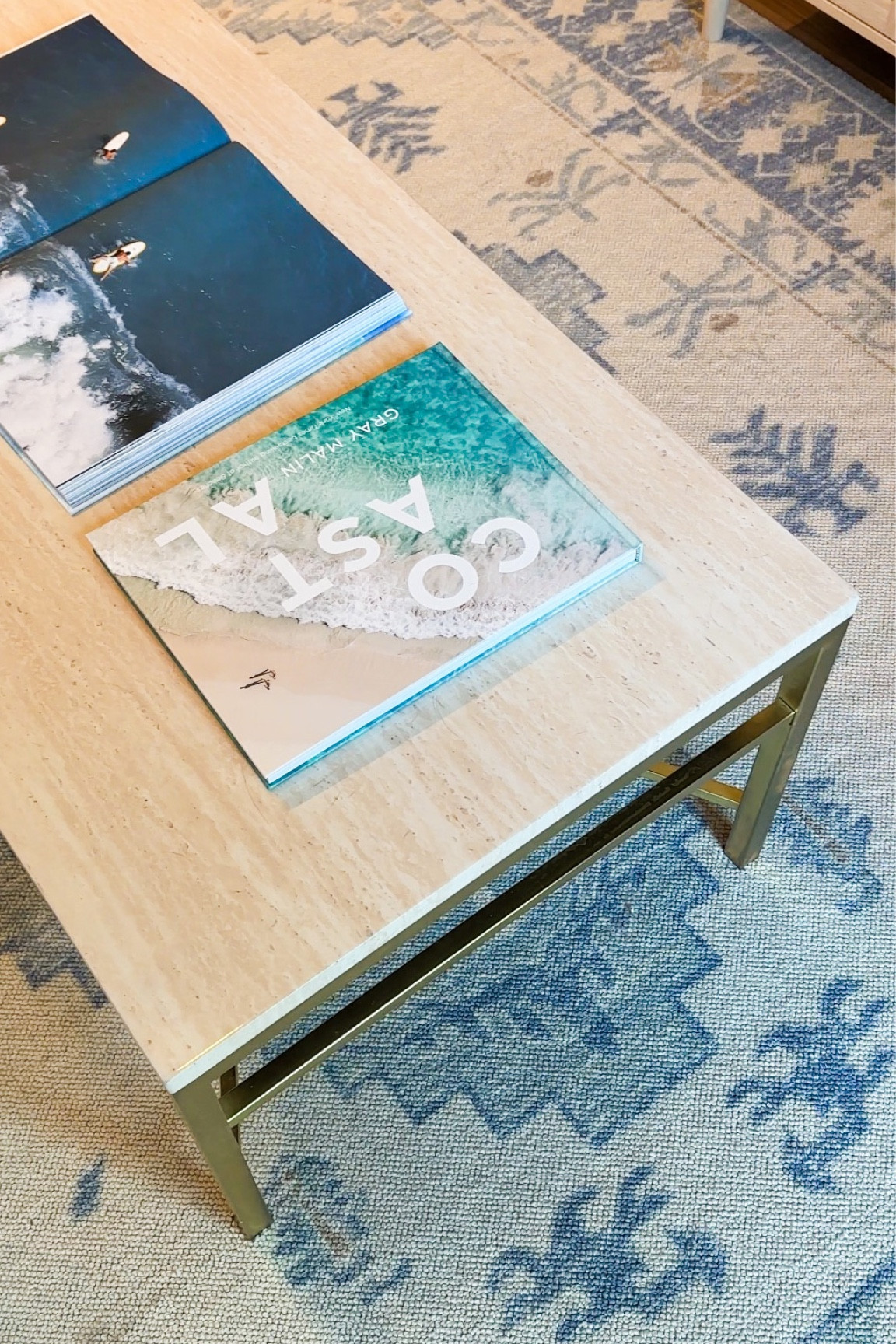 Coastal apartment, gorgeous blue rug and coffee table books!!!