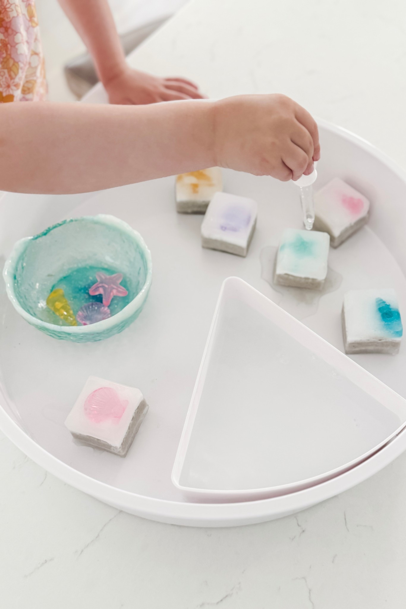 Camp Magic Playbook — Beach Week

Ice cube seashell rescue play tray 🧊🐚 
I wasn’t quite sure how these sandy cubes would turn out, but I love the result! I started with a shallow layer of water with a seashell in each square, then a thin layer of shaving cream (dissolved in water), and then the rest is water-soaked sand. My #LTKTodder had sooo much fun with this activity — 10/10 will be doing again!

*this beachy resin bowl is from @threeletterwordsbykatie 

#LTKKids