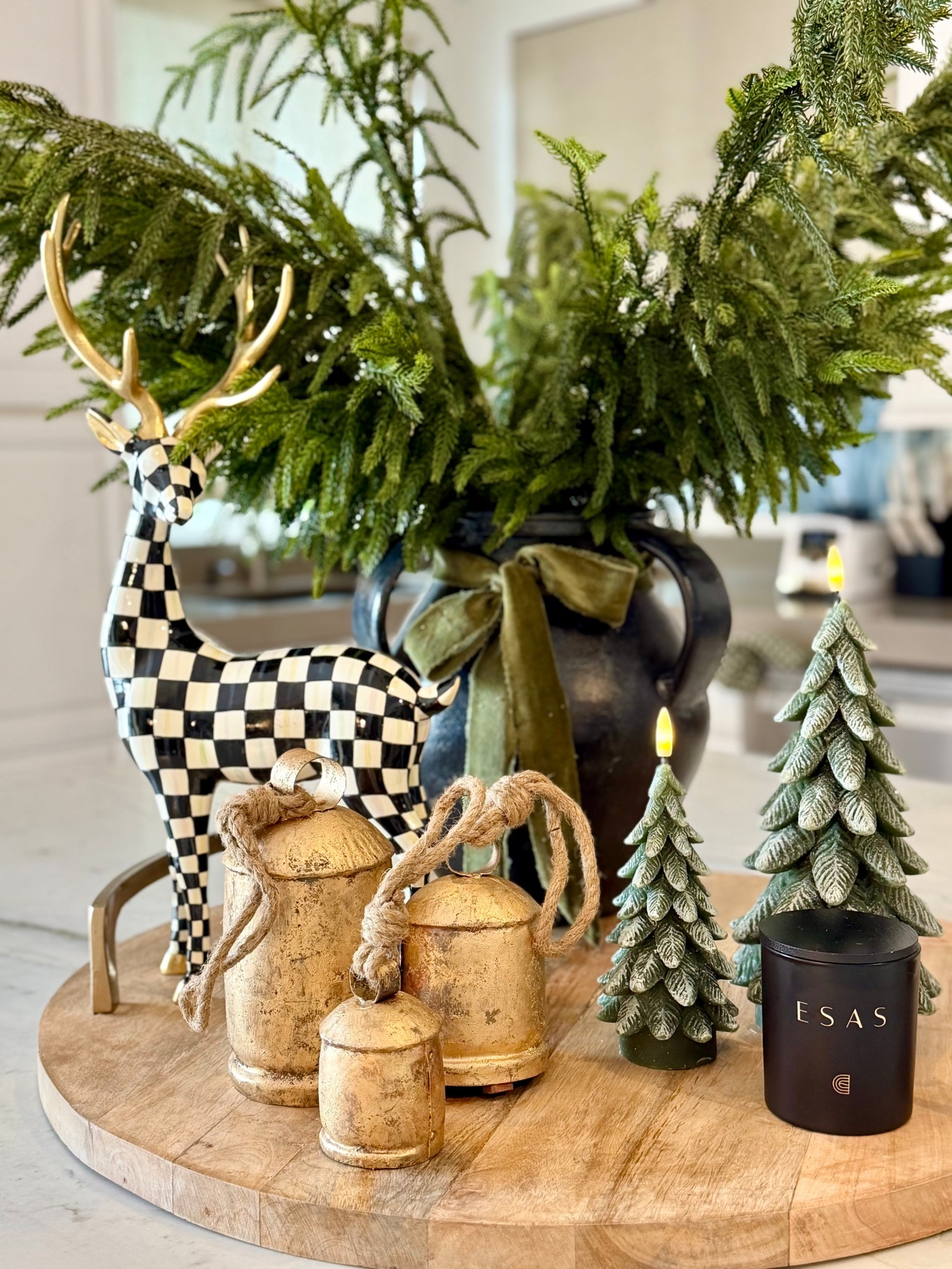 A simple and stunning Christmas countertop moment. 🦌 

I added faux pine branches to a large vase, tied with a velvet ribbon bow. Displayed my favorite Mackenzie Childs deer, flameless tree candles, gold cow bells, and a clean burning nontoxic candle. Loving the mix of black, white, gold, and green for a look that feels both festive and elevated. Creating amA Pretty Living for the season. 🖤🌲🤍








#ChristmasDecor
#HolidayStyling
#KitchenCounterDecor
#FestiveHome
#HolidayAesthetic
#PrettyLiving
#ChristmasInspo
#ModernHolidayDecor
#NeutralChristmasDecor
#CozyHolidayHome
#SeasonalStyling
#ChristmasVibes
#HolidayHomeDecor
#HolidayDetails
#TimelessChristmas Decor

#LTKSeasonal #LTKHome #LTKHoliday