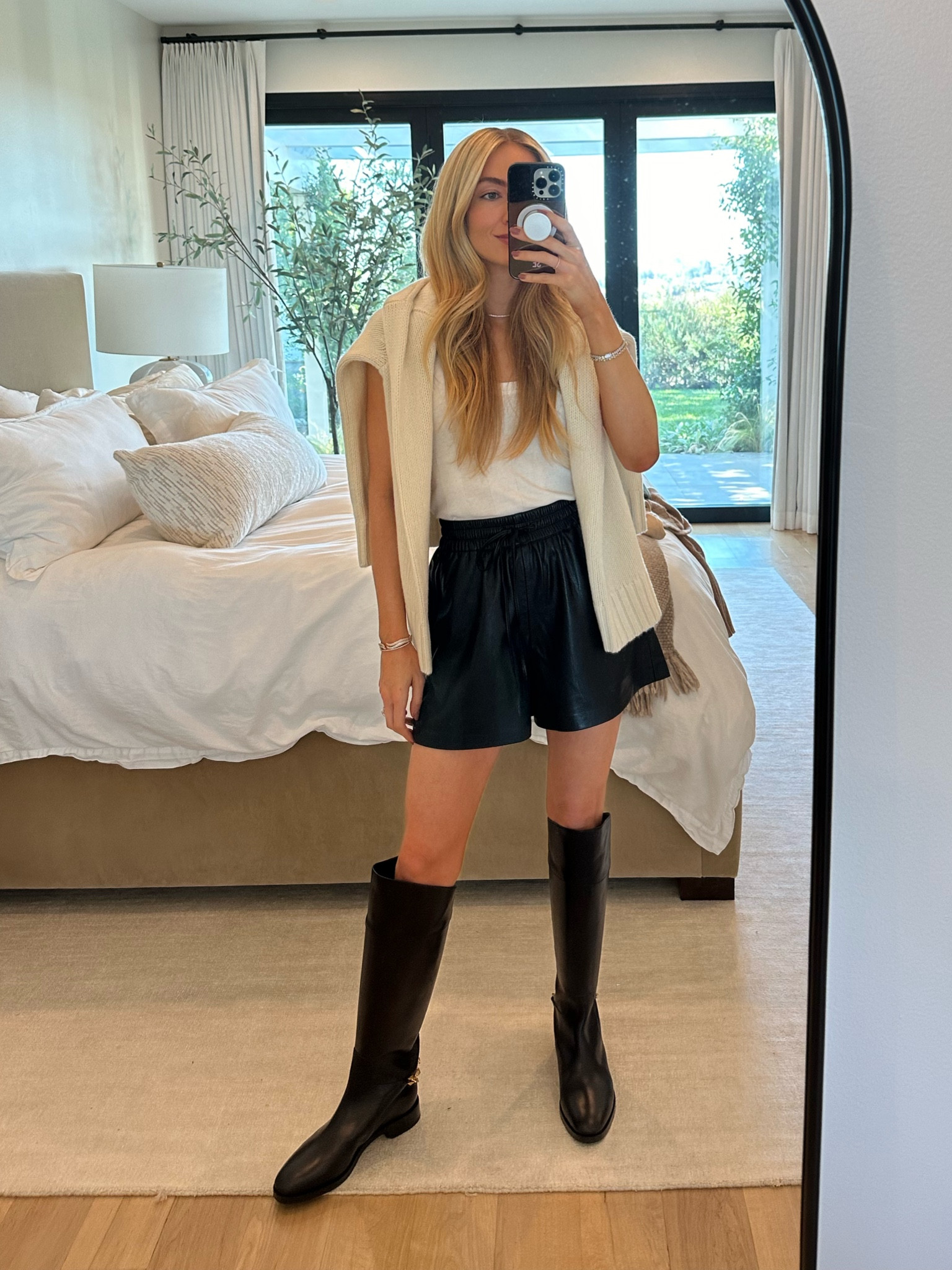 Heading down to San Diego for the day and pulled out these new faux leather shorts - they’re so light and comfortable with a stretchy drawstring waist and tie. Paired them with a cream cashmere knit sweater and black riding boots 🤍

Use code SE15 for 15% off the cream sweater and anything else Jenni Kayne!

Sizes worn here:
Tank XS (TTS)
Sweater XS (runs oversized) use code SE15
Shorts 0 (TTS)
Boots 40 (run on the smaller side, I sized up a bit)