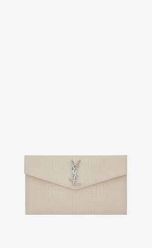Small envelope pouch with a flap decorated with metal YSL initials. | Saint Laurent Inc. (Global)