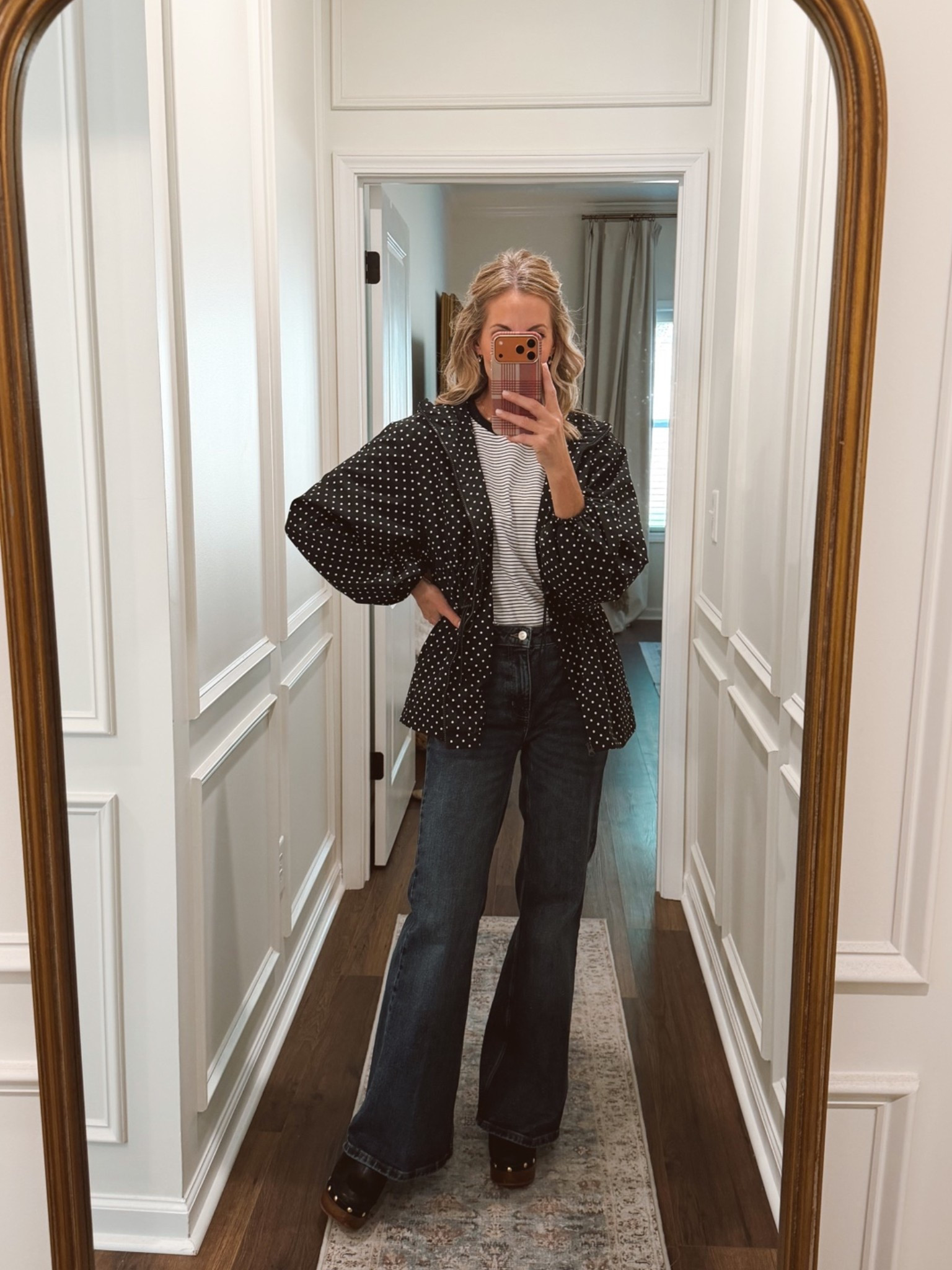 Cinched waist raincoat. Perfect for fall also comes in white with black polkadots. Wearing a size small love it with the striped Walmart tee and jeans.