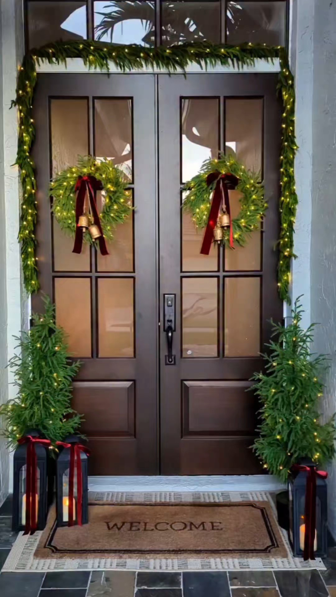Christmas front porch decor. Norfolk garlands. Norfolk wreaths. Norfolk trees. 4 ft Christmas trees. Bells. Red ribbon. Burgundy ribbon. Battery powered led lights. String lights. Black lanterns with red bows. Front porch doormat and layered rug. Battery powered candles with remote in lanterns. #Christmas #LTKfind

#LTKHoliday #LTKSeasonal #LTKHome